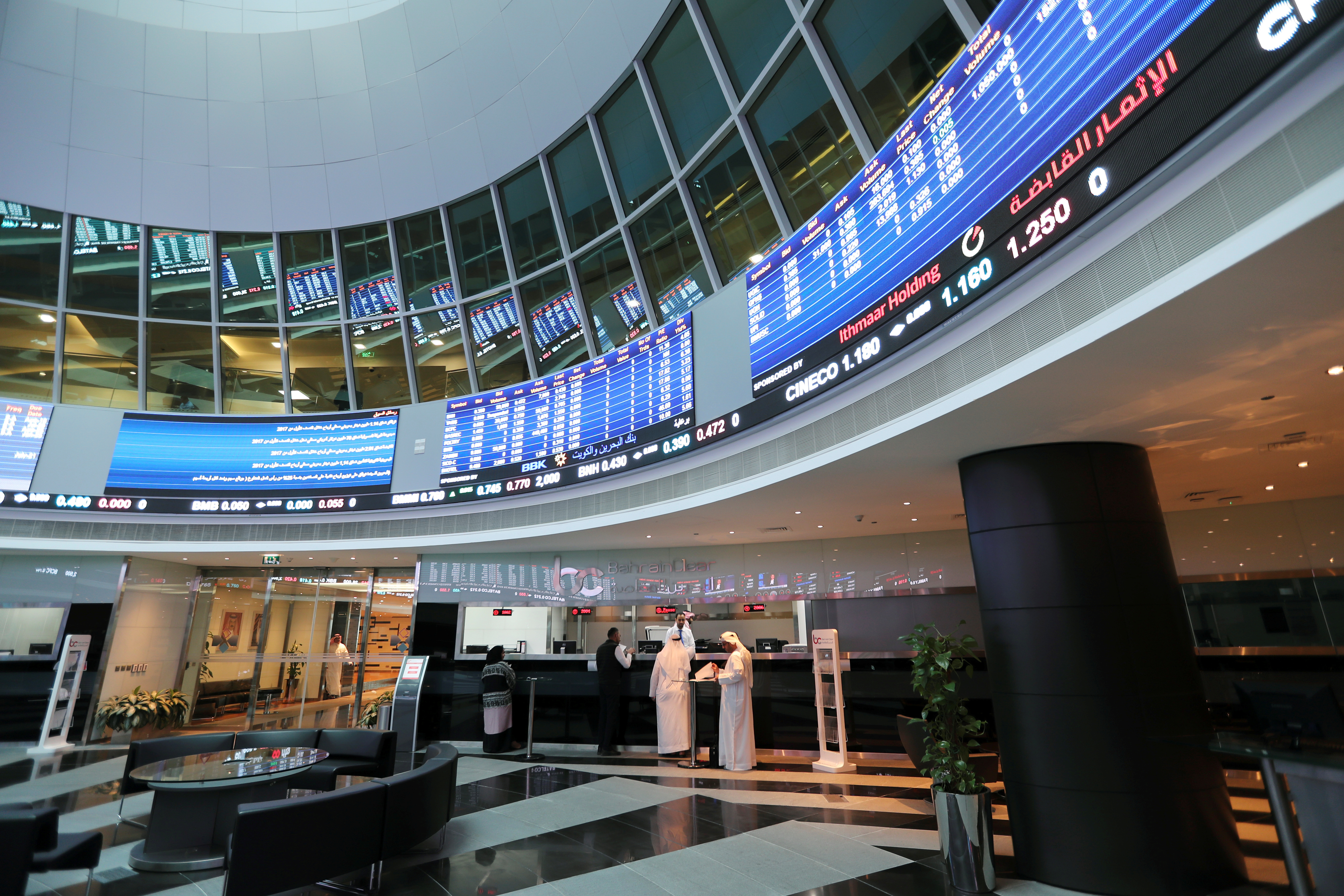 Traders talk with the officials at Bahrain Bourse in Manama