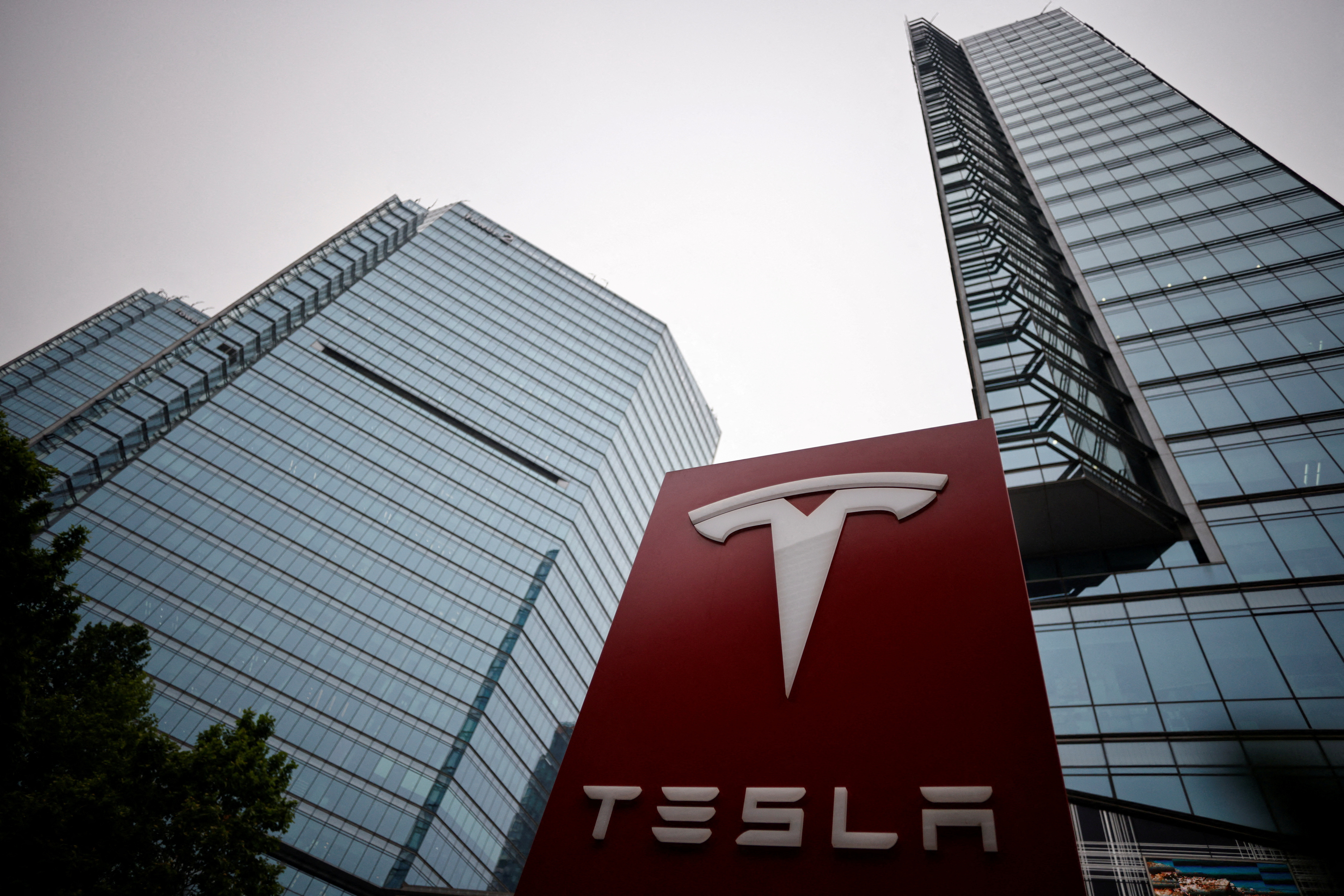 A Tesla logo is seen outside a showroom of the carmaker in Beijing