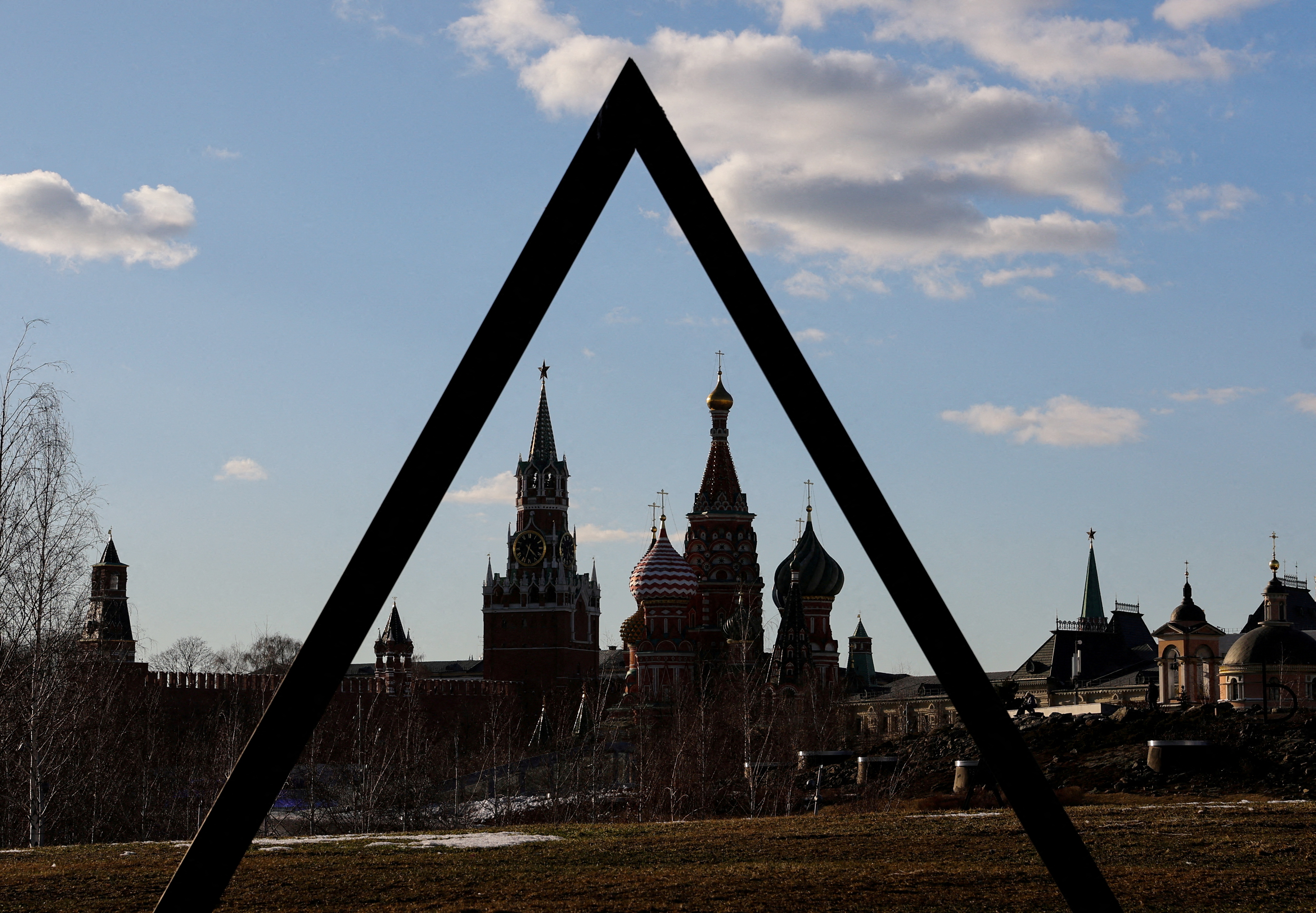 The Kremlin's Spasskaya Tower and St. Basil's Cathedral are seen through the art object in Zaryadye park in Moscow