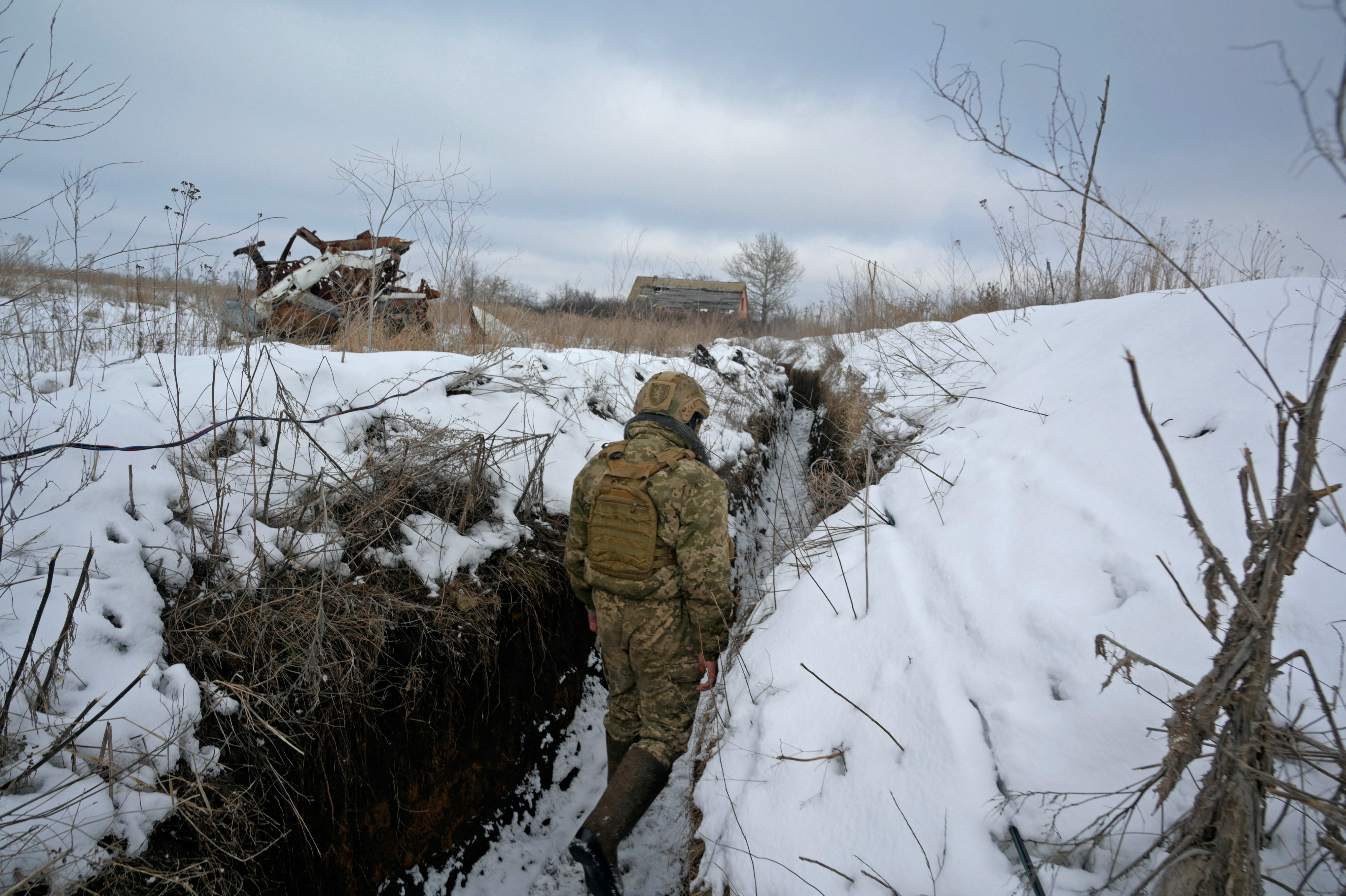 A service member of the Ukrainian armed forces walks at combat positions in Luhansk Region