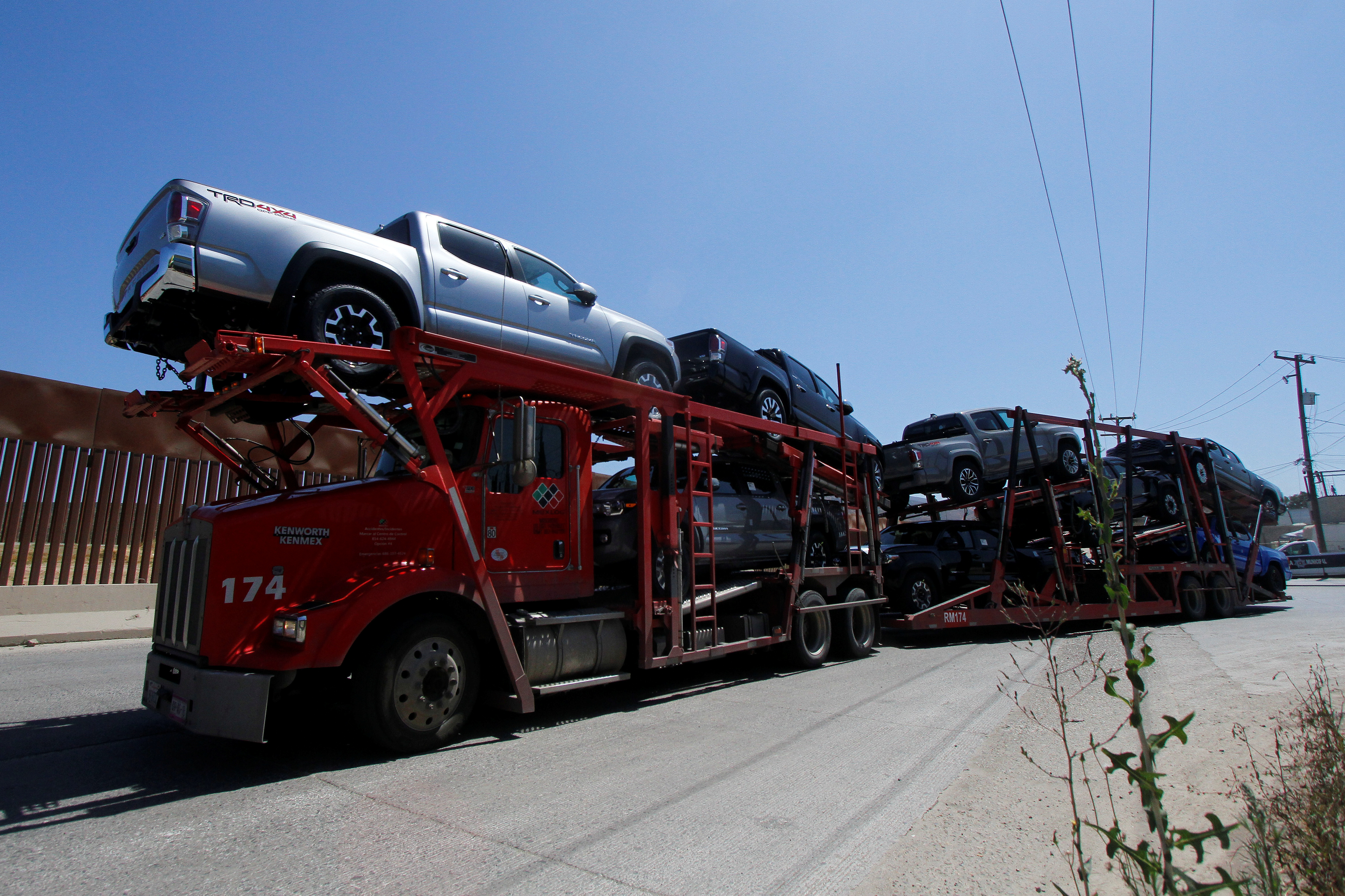 A carrier trailer transports Toyota vehicles for delivery while queuing at the border for customs control to cross into the U.S., at the Otay border crossing in Tijuana