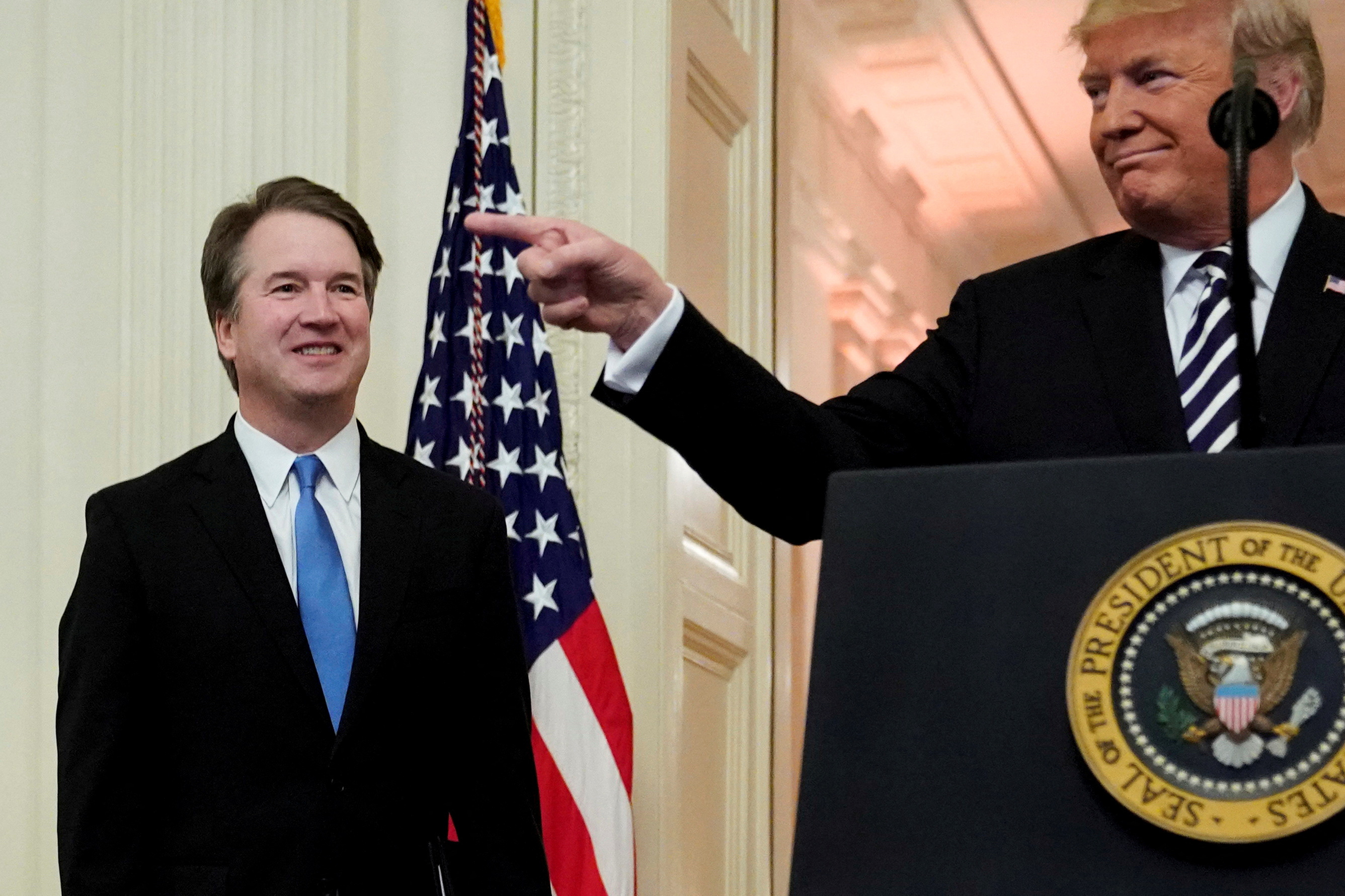 U.S. President Donald Trump speaks next to U.S. Supreme Court Associate Justice Brett Kavanaugh as they participate in a ceremonial public swearing-in at the East Room of the White House in Washington