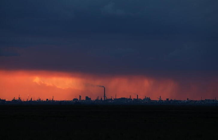 The sun sets as storm clouds are seen over Sasol's chemicals plant in Sasolburg