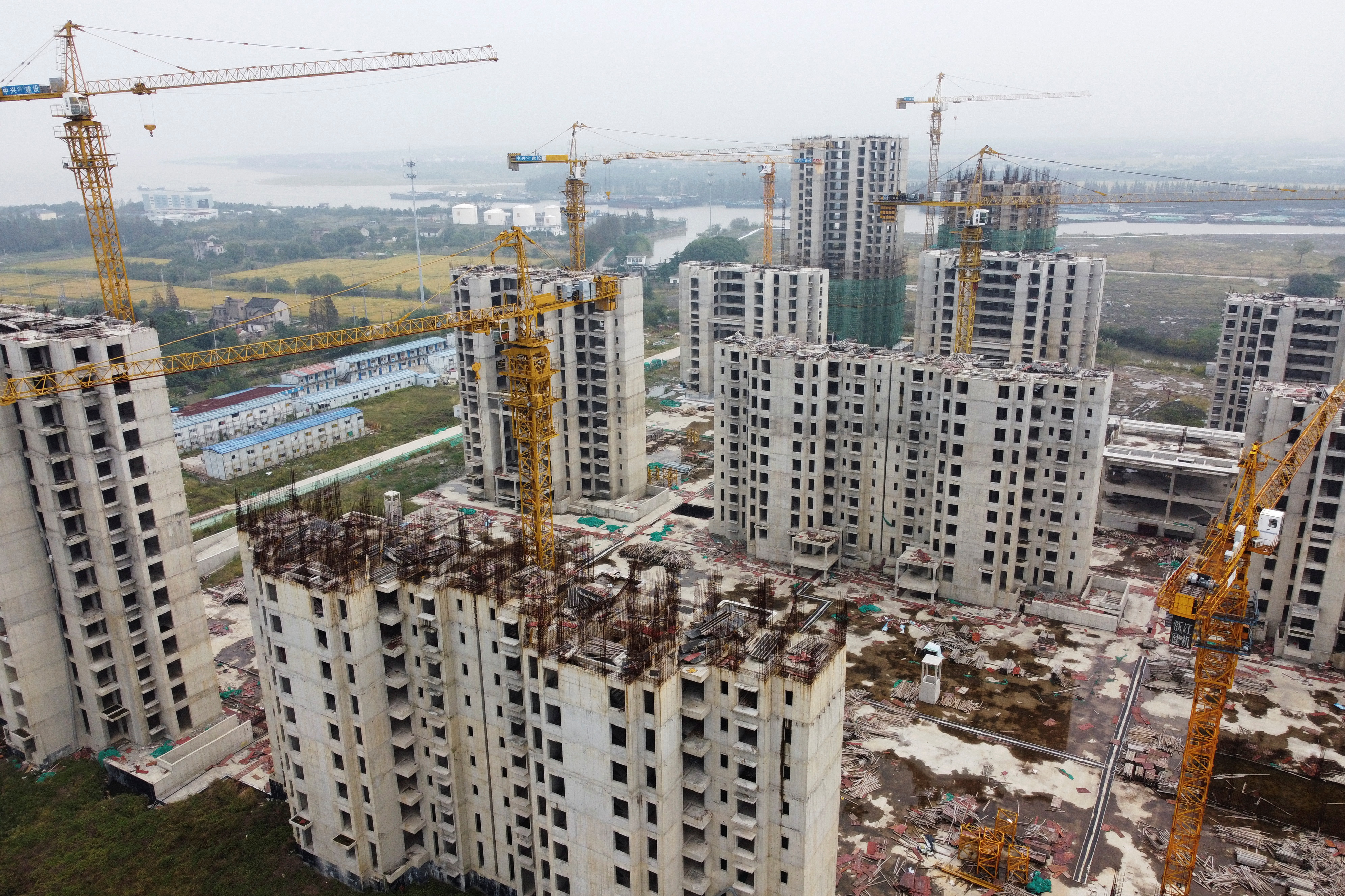 An aerial view shows residential buildings at the construction site of Evergrande Cultural Tourism City, a China Evergrande Group project whose construction has halted, in Suzhou's Taicang, Jiangsu province, China October 22, 2021. Picture taken with a drone.  REUTERS/Xihao Jiang 