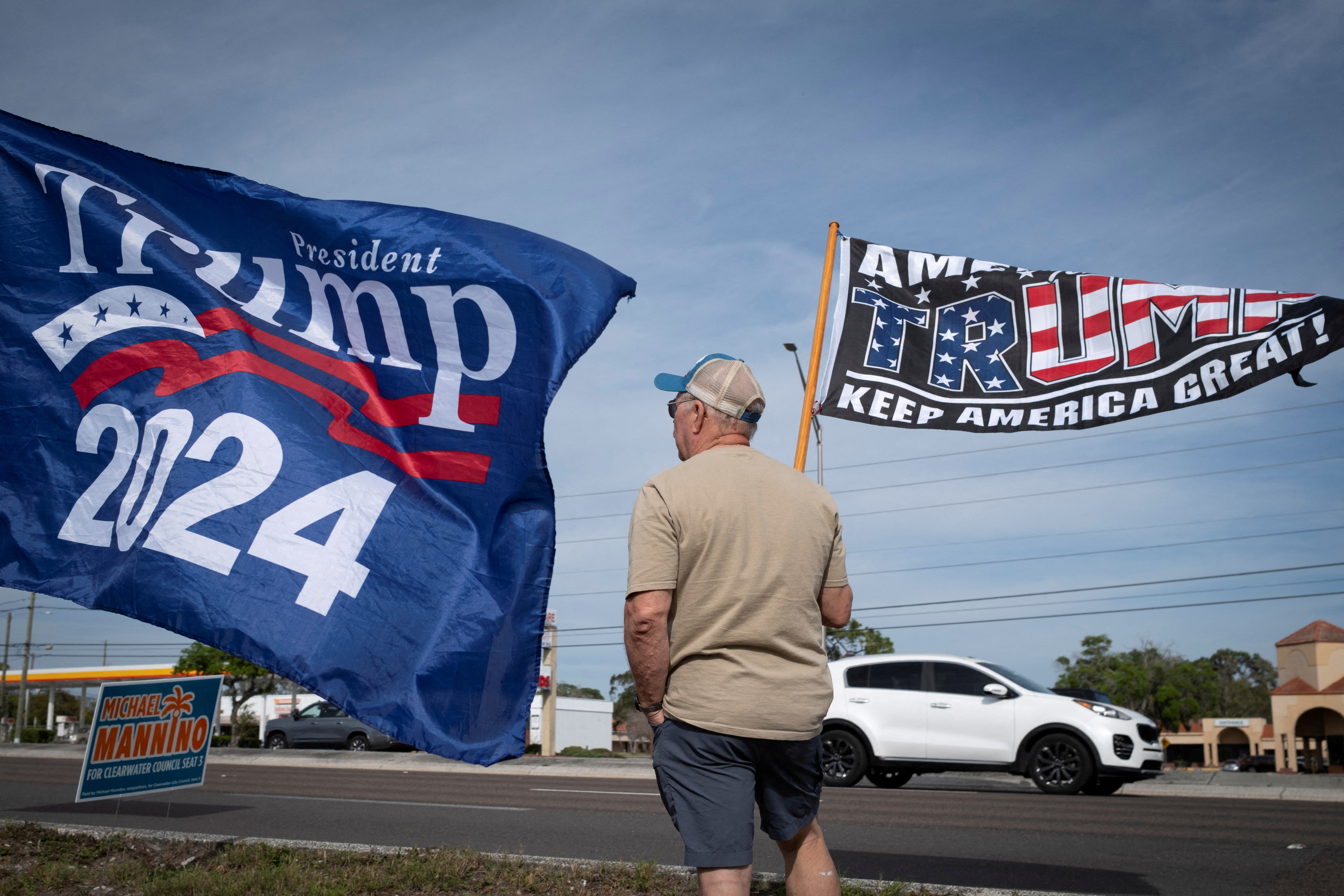 Supporters of former U.S. President Donald Trump wave flags in Palm Harbor