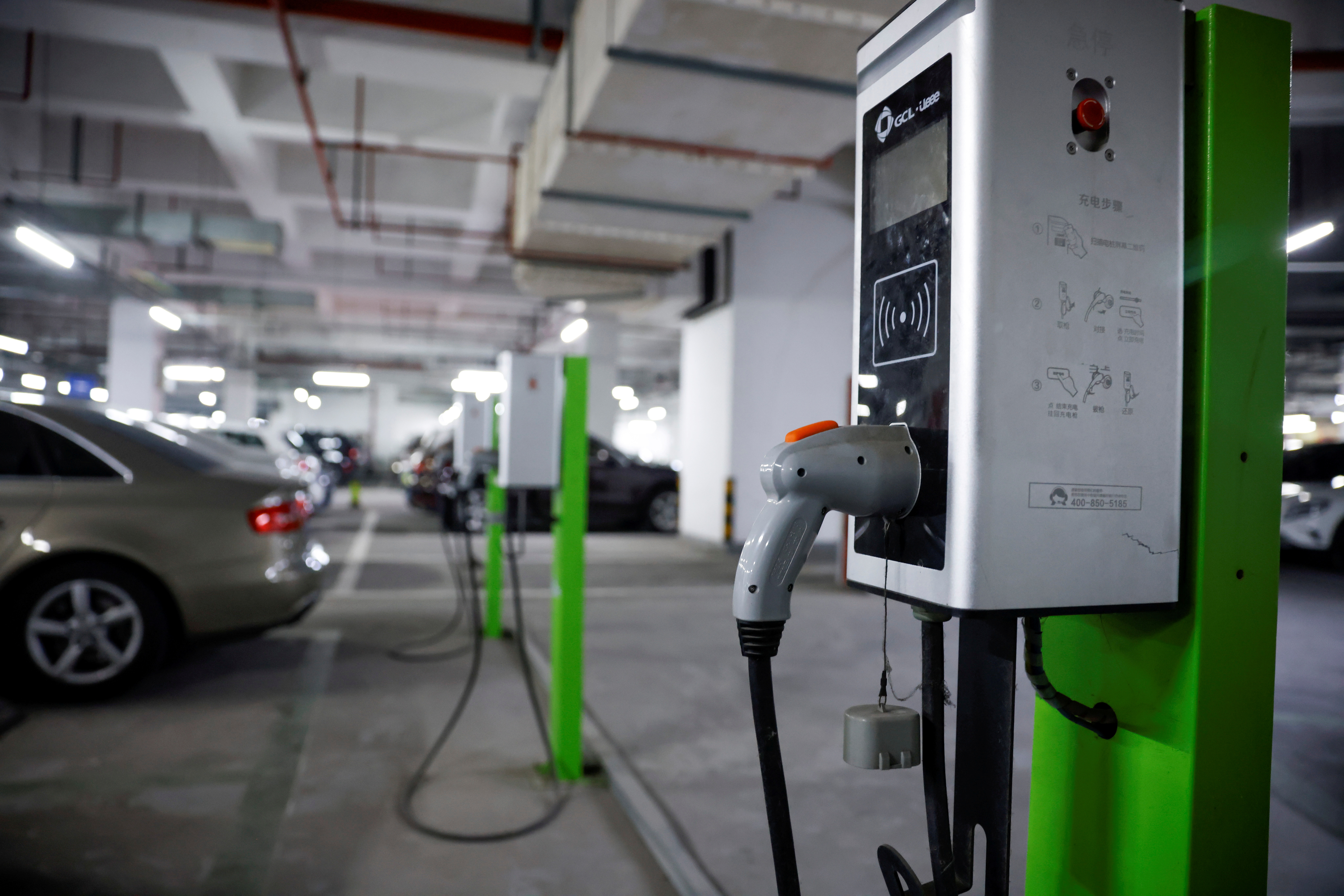 A electric car charging station is pictured in a parking lot in Shanghai, China March 13, 2021. REUTERS/Aly Song/File Photo