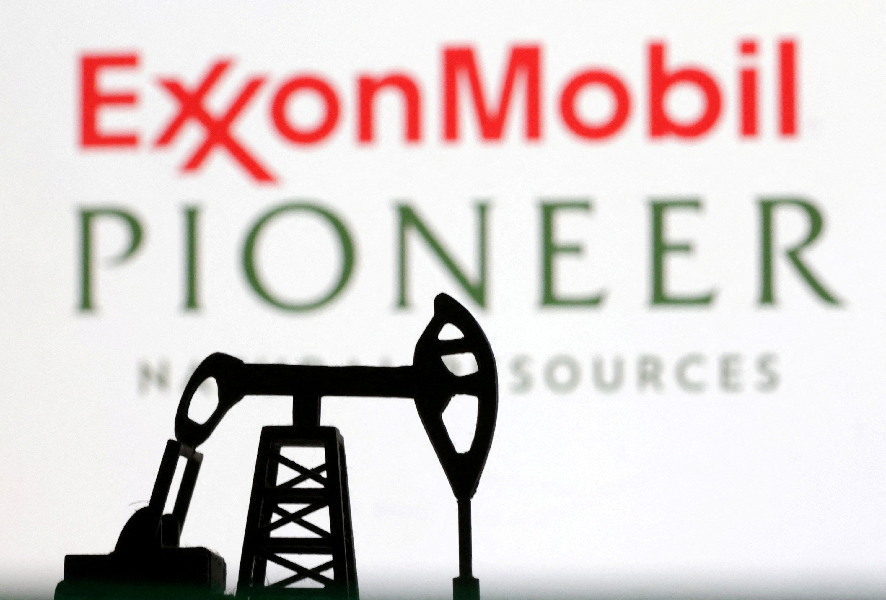 Illustration shows ExxonMobil and Pioneer Natural Resources logos