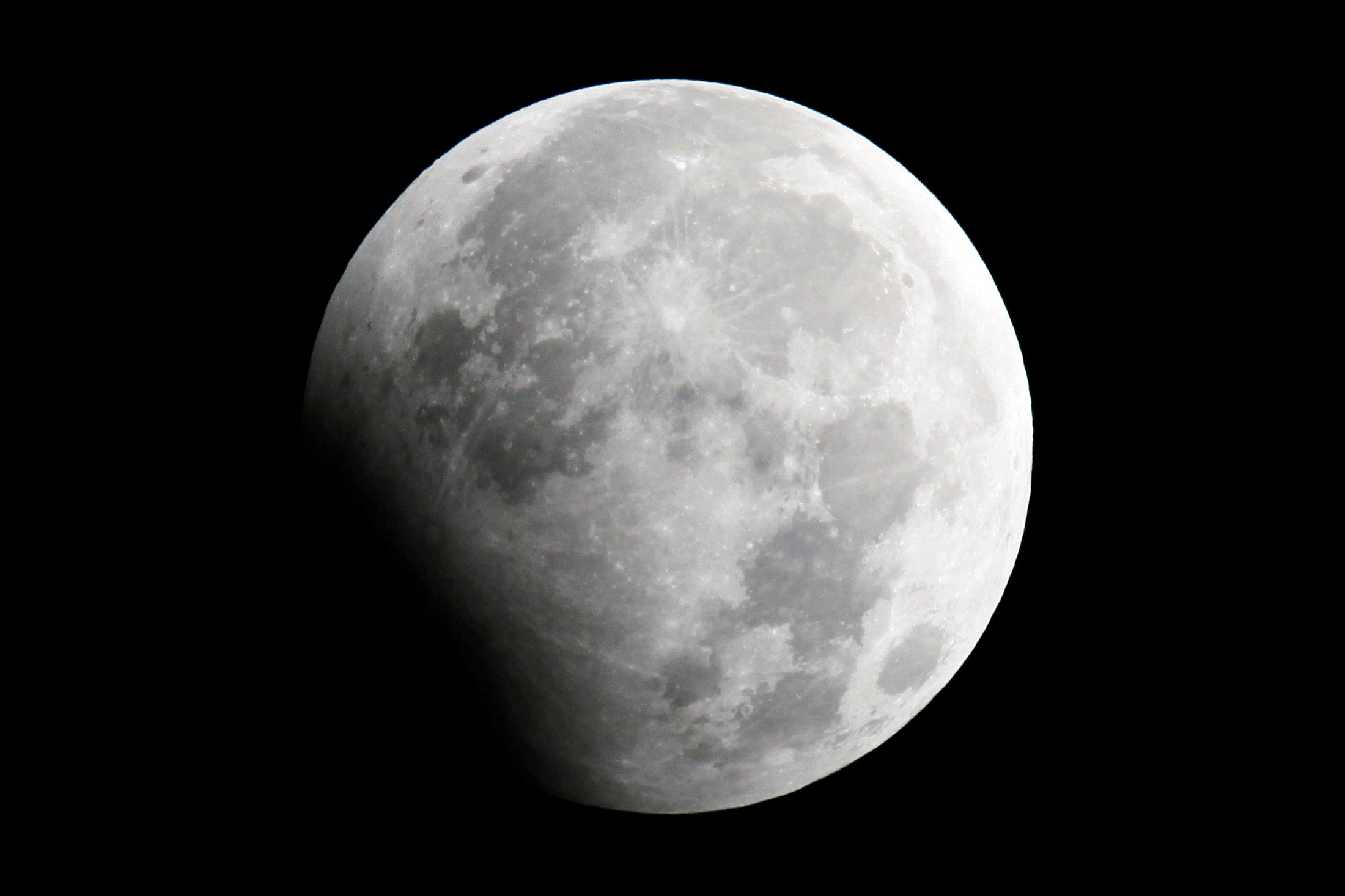 The moon is seen during a partial lunar eclipse in Shanghai