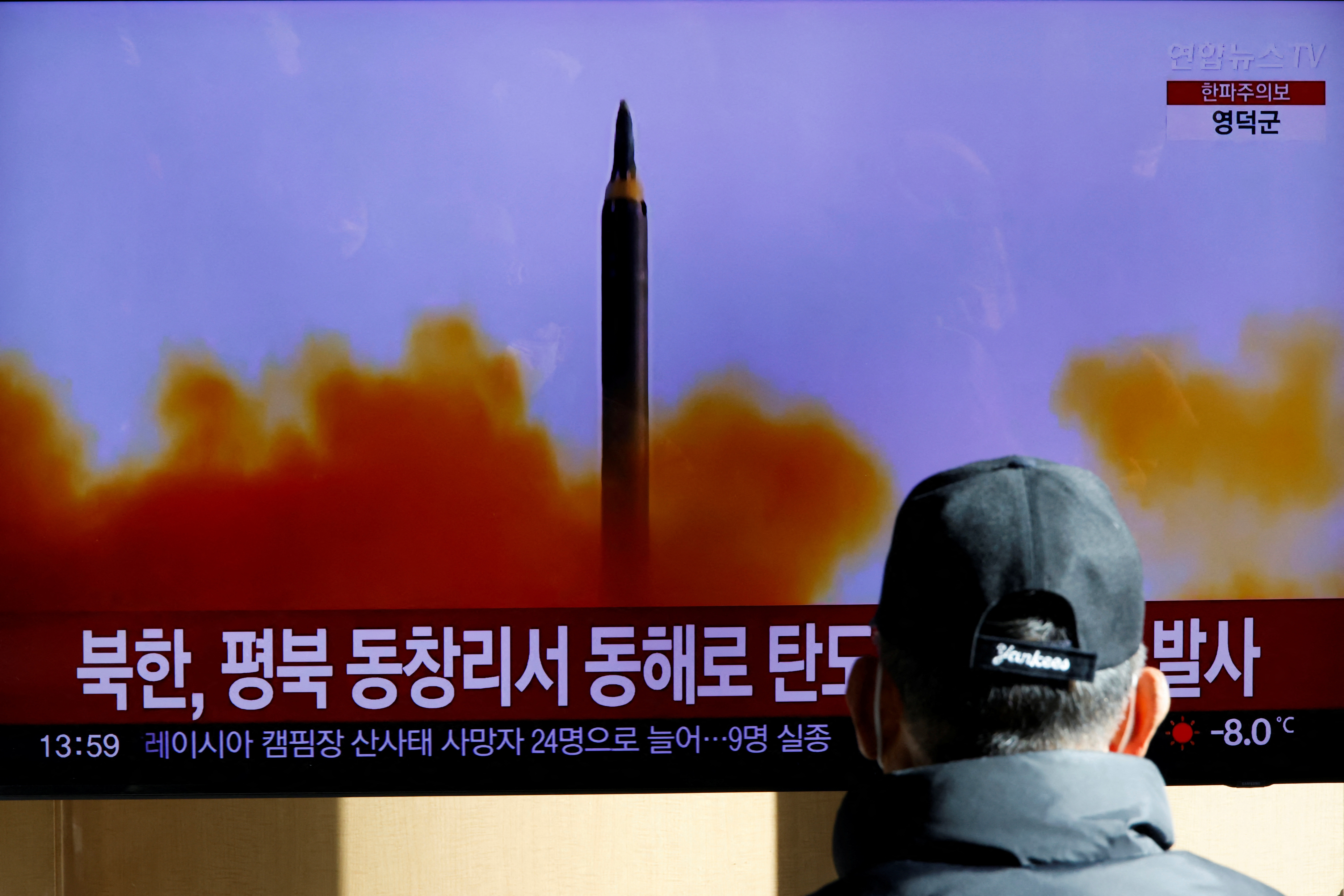A man watches a TV broadcasting a news report on North Korea firing a ballistic missile off its east coast, in Seoul