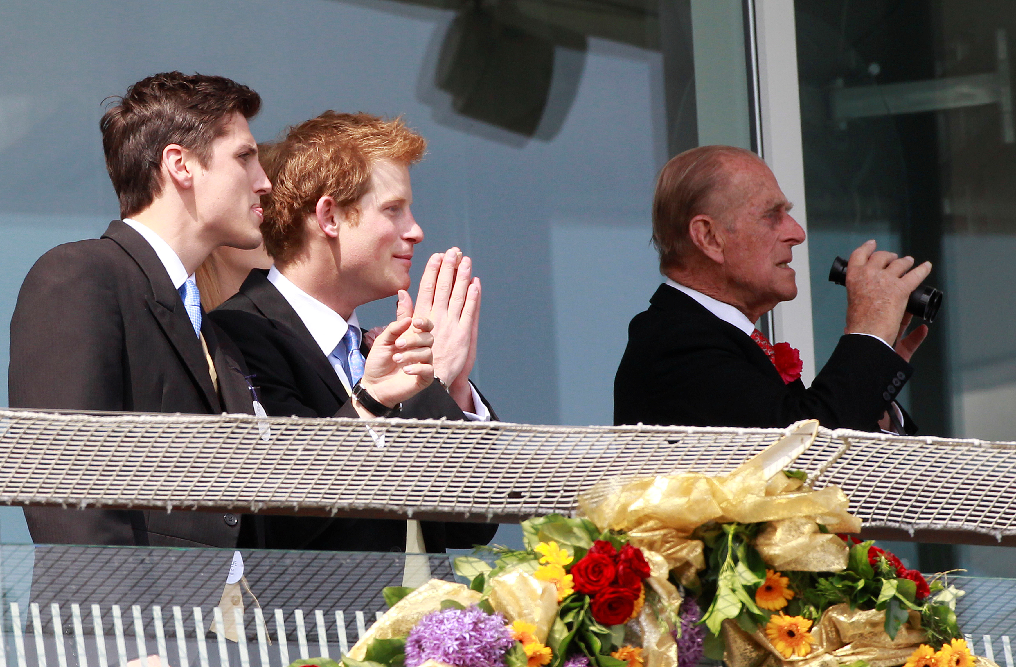 Britain's Prince Harry and Prince Philip watch the 3:15 race at Epsom Racecourse in southern England