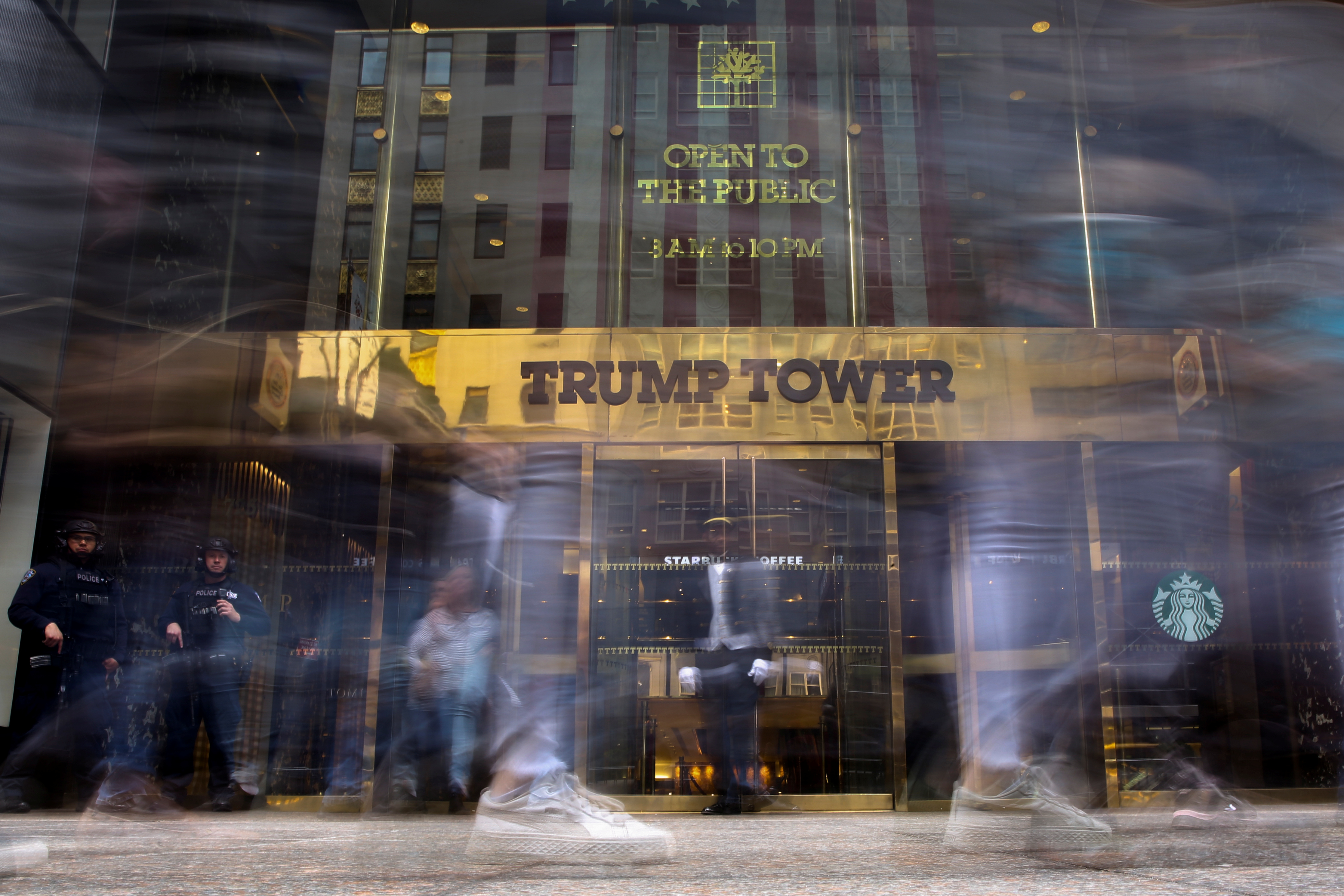 Pedestrians walk past and take pictures in front of the Trump Tower on 5th Avenue in the Manhattan borough of New York City, New York, U.S., April 18, 2019. REUTERS/Caitlin Ochs