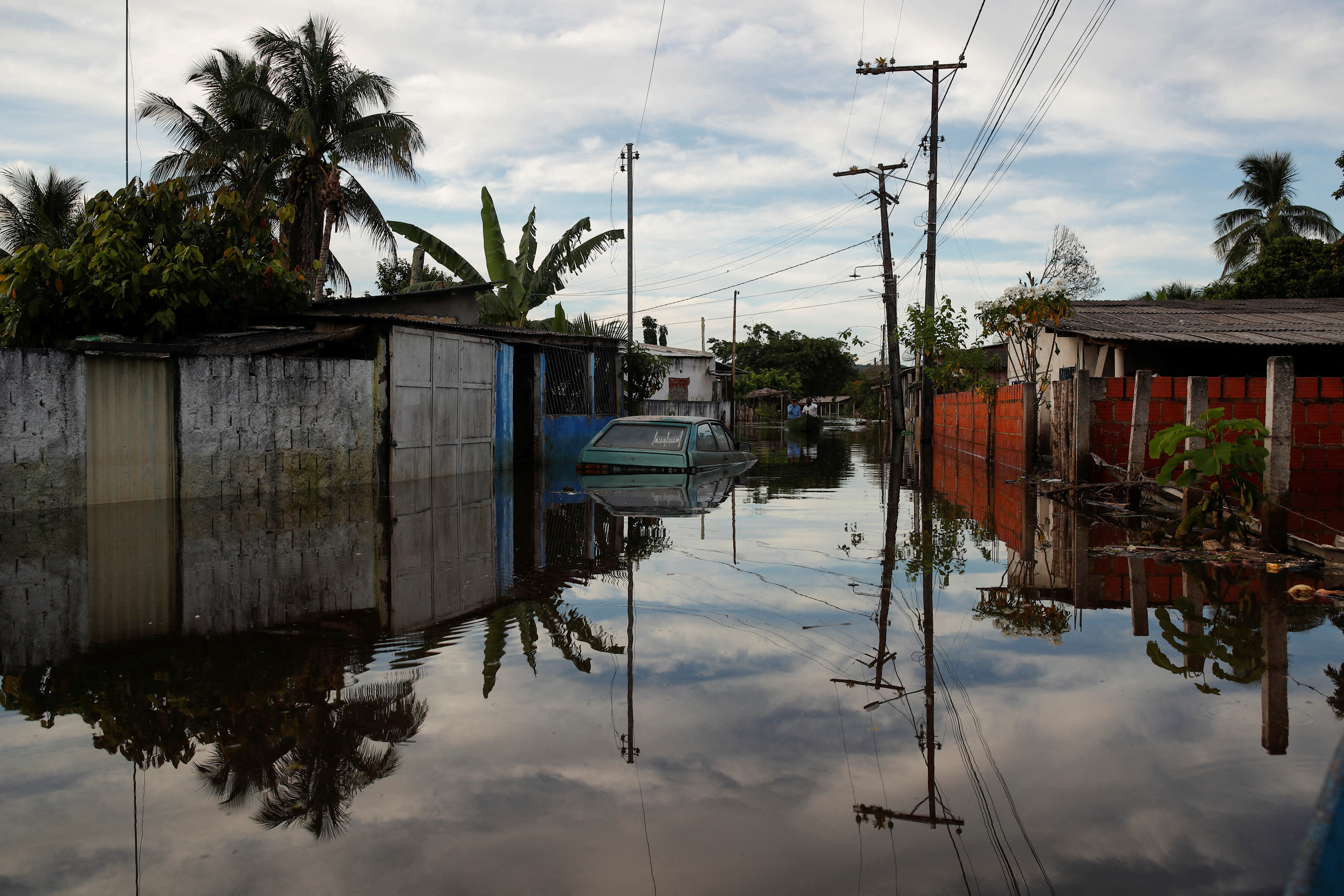 A partially submerged car is seen in a flooded street at Sambaituba in Ilheus, Bahia state, Brazil December 29, 2021. REUTERS/Amanda Perobelli