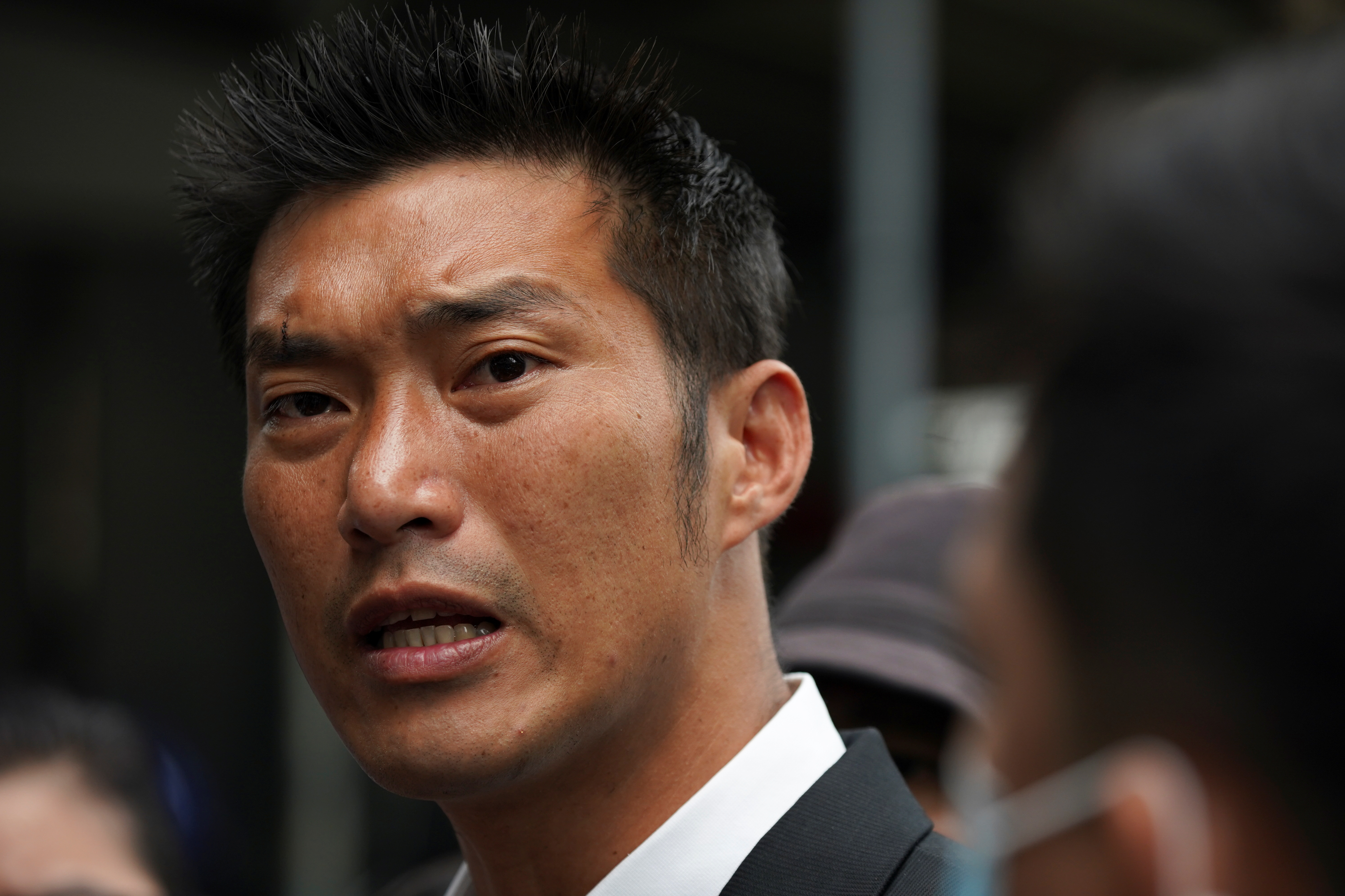 Banned opposition politician Thanathorn Juangroongruangkit turns up at a police station after police charged him with defaming the monarchy, in Bangkok