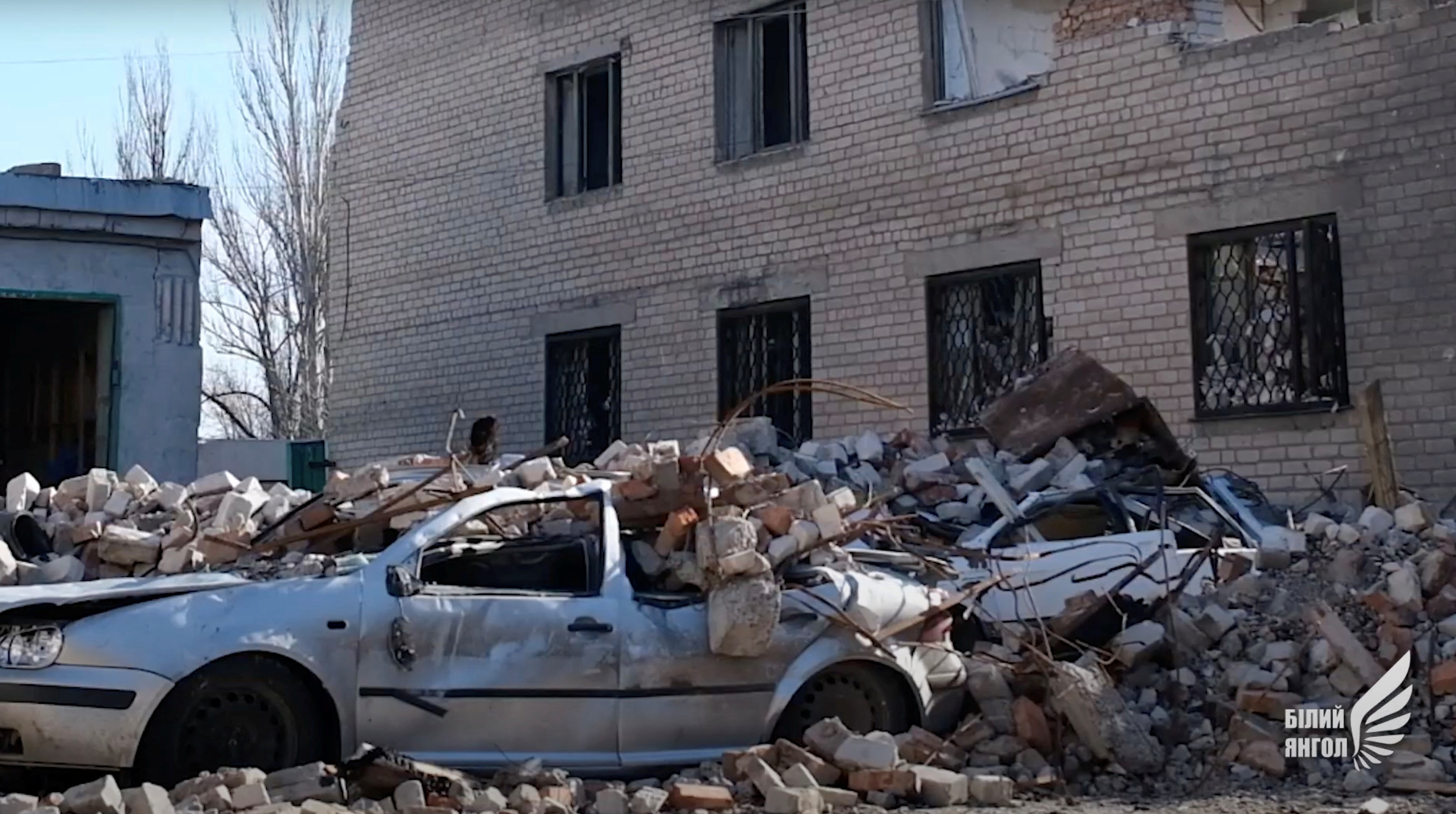 General view shows a car damaged by debris in Avdiivka