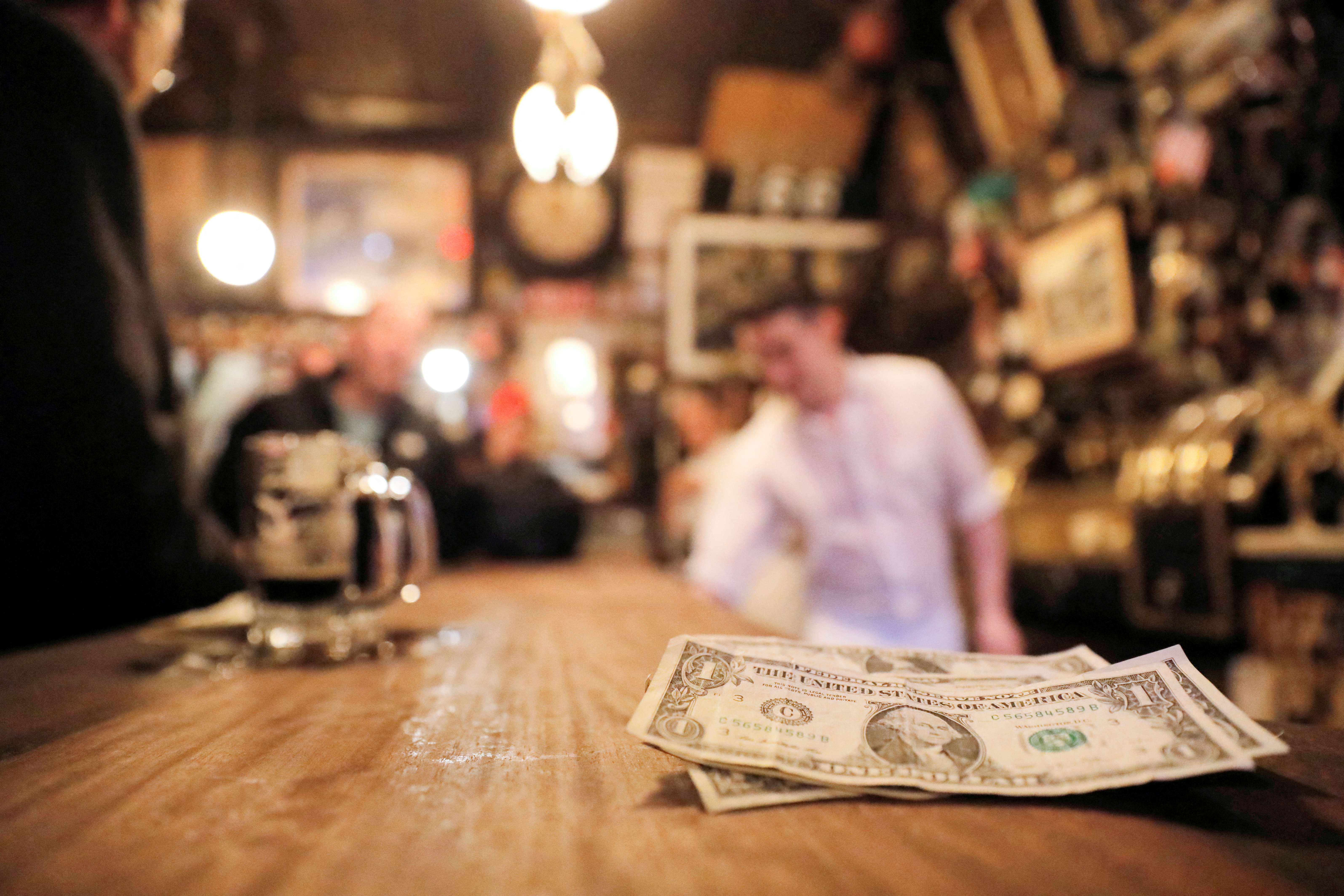Tips are seen on the bar at McSorley's Old Ale House, which, established in 1854, is referred to as New York City's oldest Irish saloon and was ordered to close at 8:00pm as part of a city-wide order to close bars and restaurants