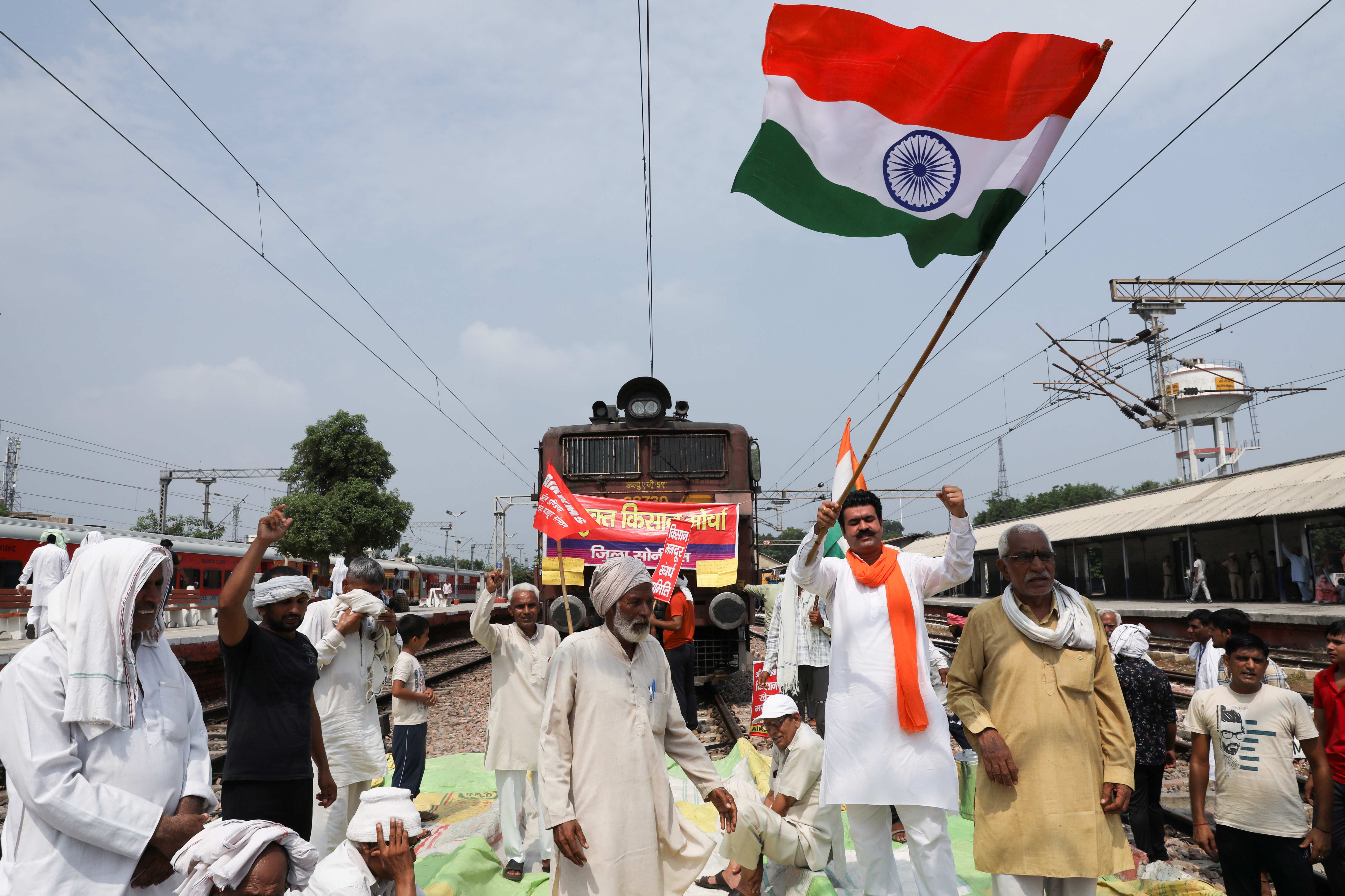 Farmers block railway tracks as part of protests against farm laws during nationwide protests, in Sonipat, northern state of Haryana, India, September 27, 2021. REUTERS/Anushree Fadnavi