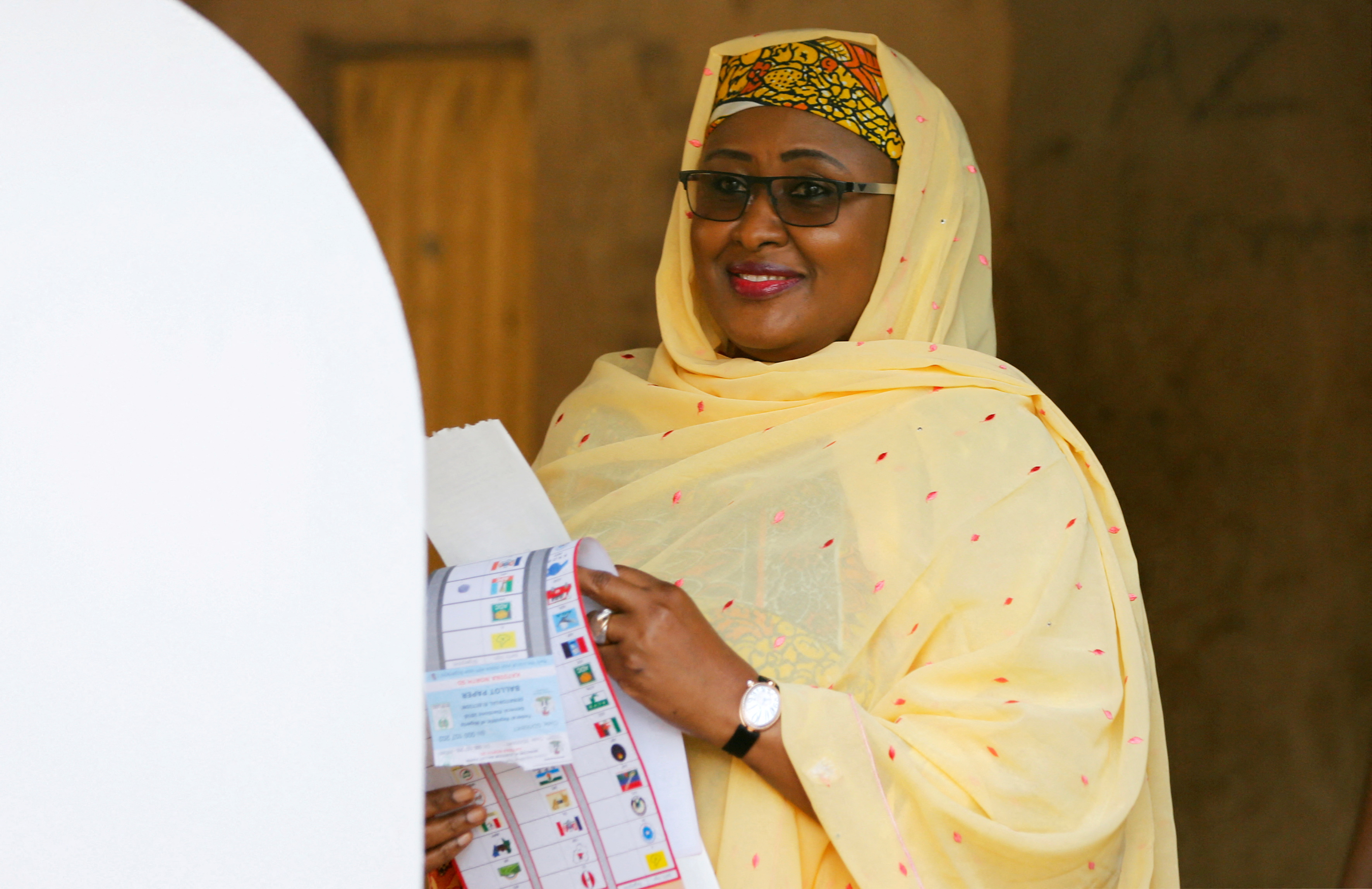 Nigerian President Muhammadu Buhari's wife Aisha Buhari holds a voting ballot as she attends Nigeria's presidential election at a polling station in Daura, Katsina State, Nigeria, February 23, 2019