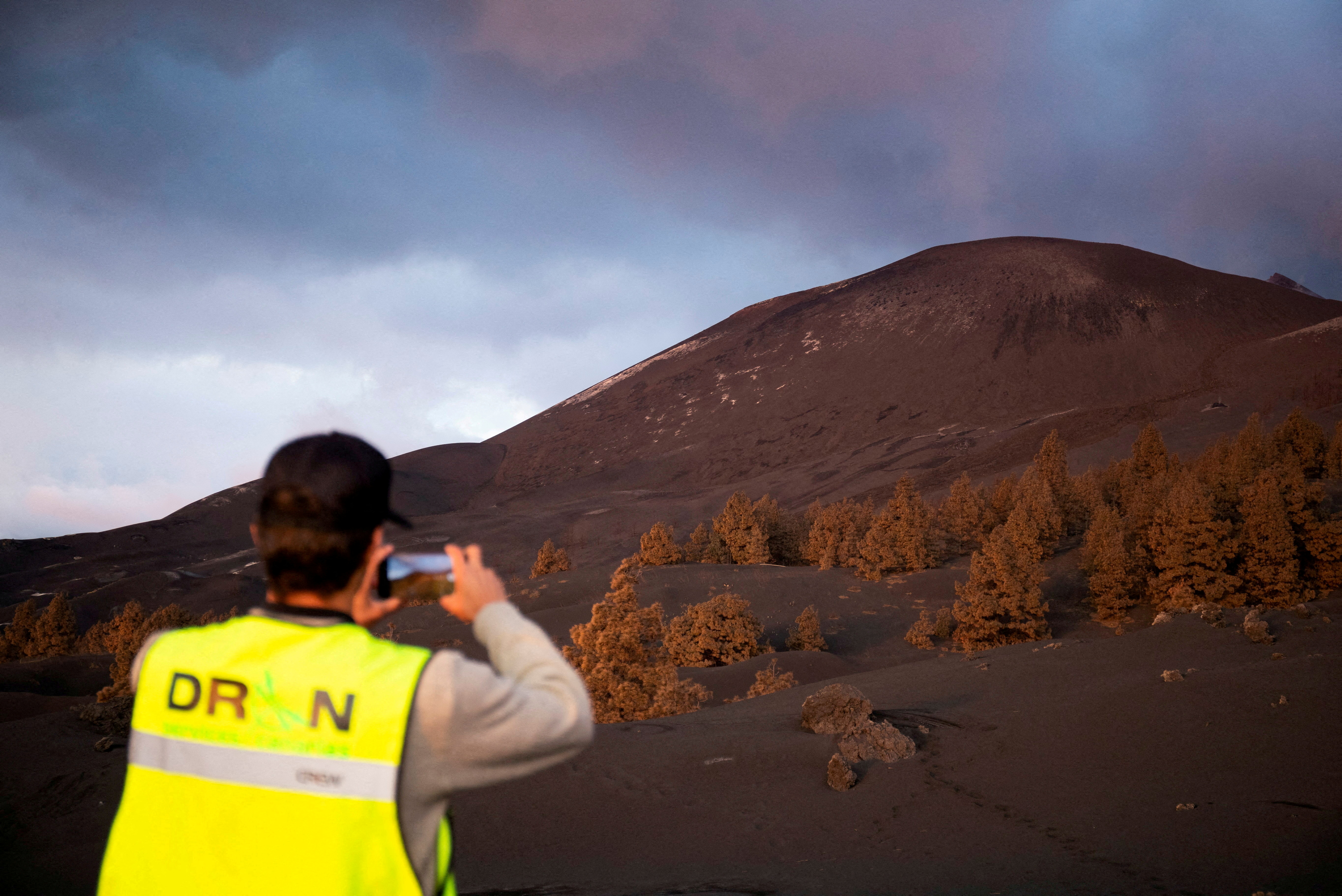 A drone pilot takes a picture of the mountain created by the eruption of the Cumbre Vieja volcano after of 89 days of its start, in the area of Las Manchas, in El Paso, on the Canary Island of La Palma, Spain, December 17, 2021. REUTERS/Borja Suarez