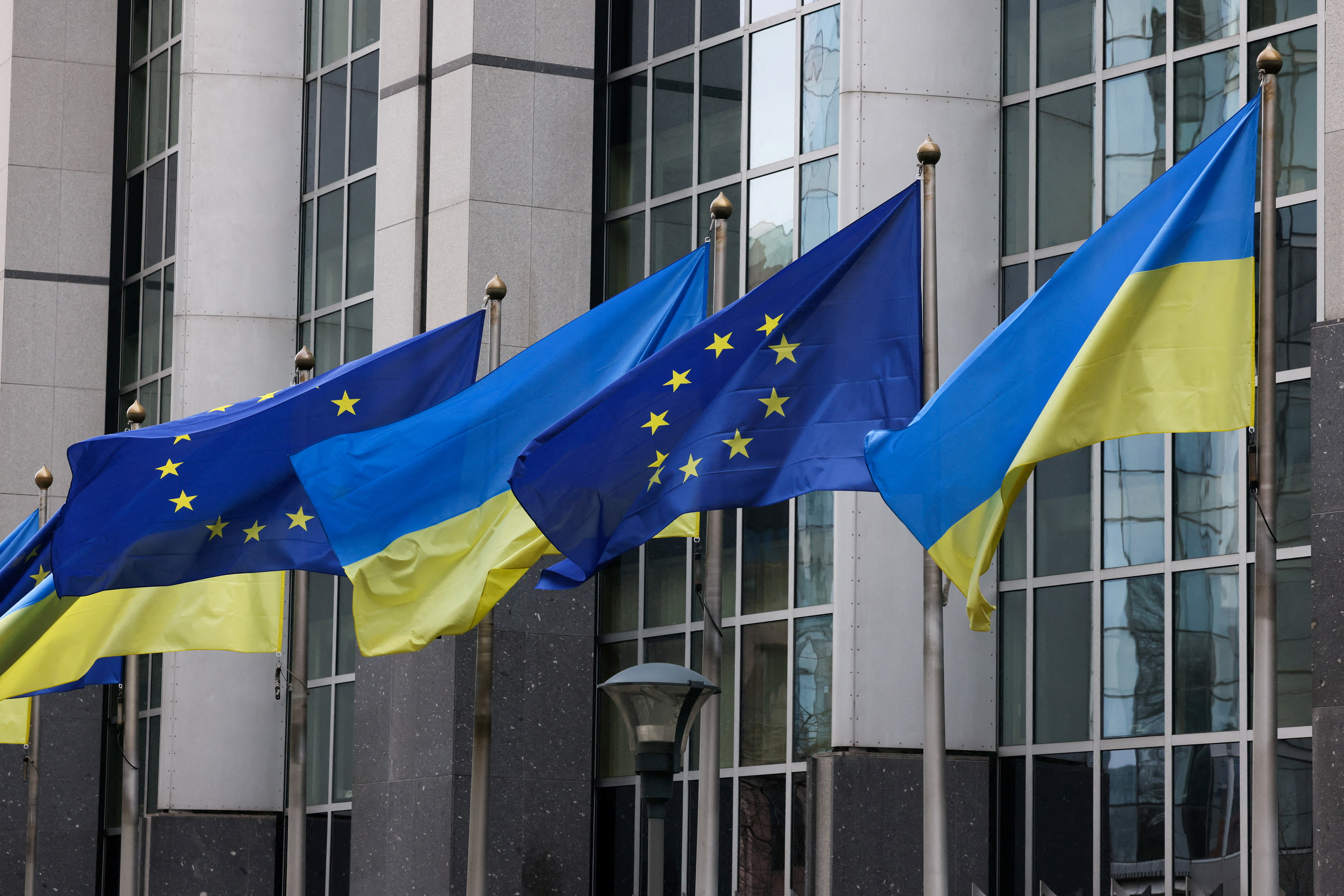 Flags of Ukraine fly in front of the EU Parliament building on the first anniversary of the Russian invasion