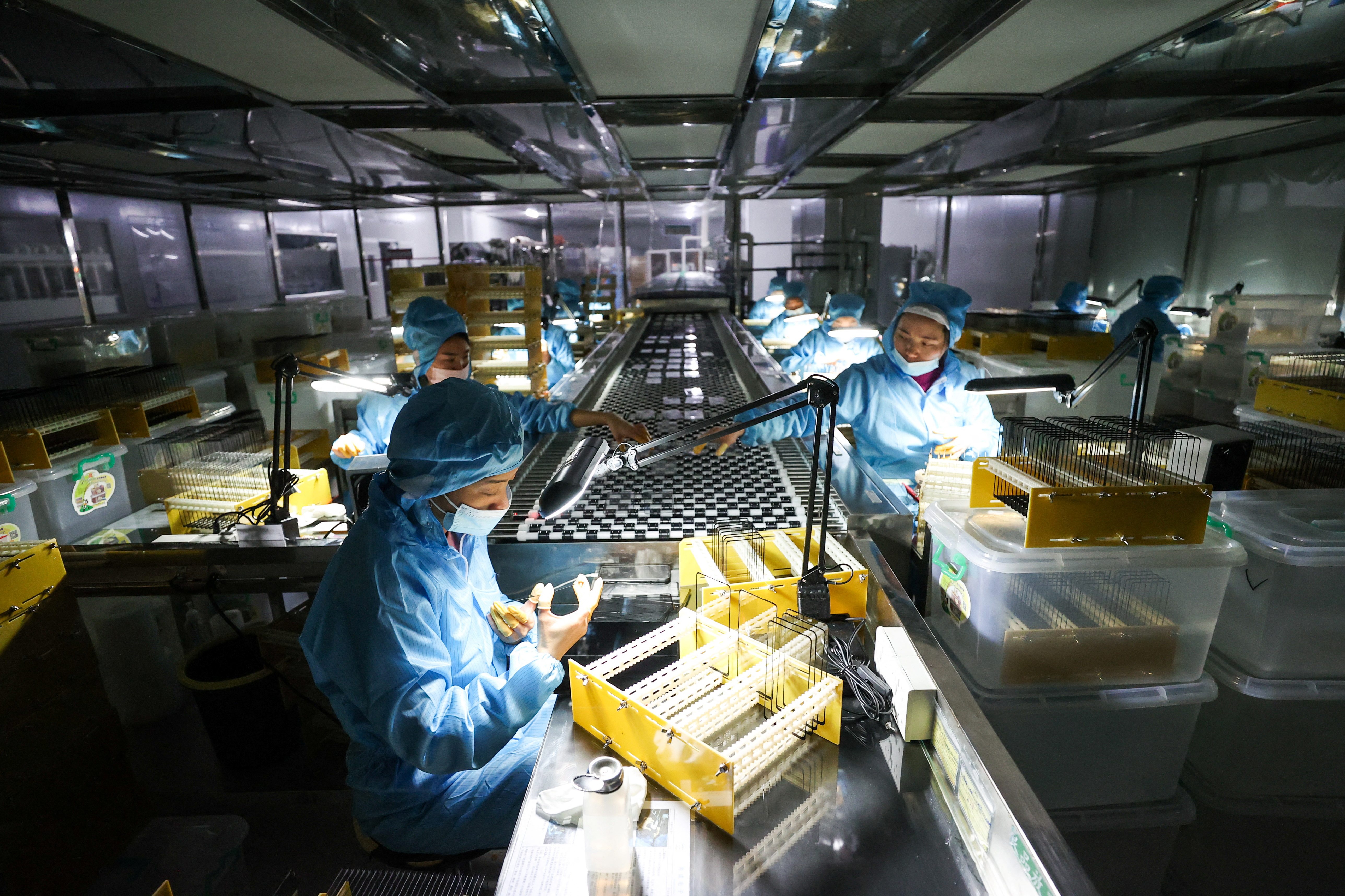 Employees work at a factory in Zunyi