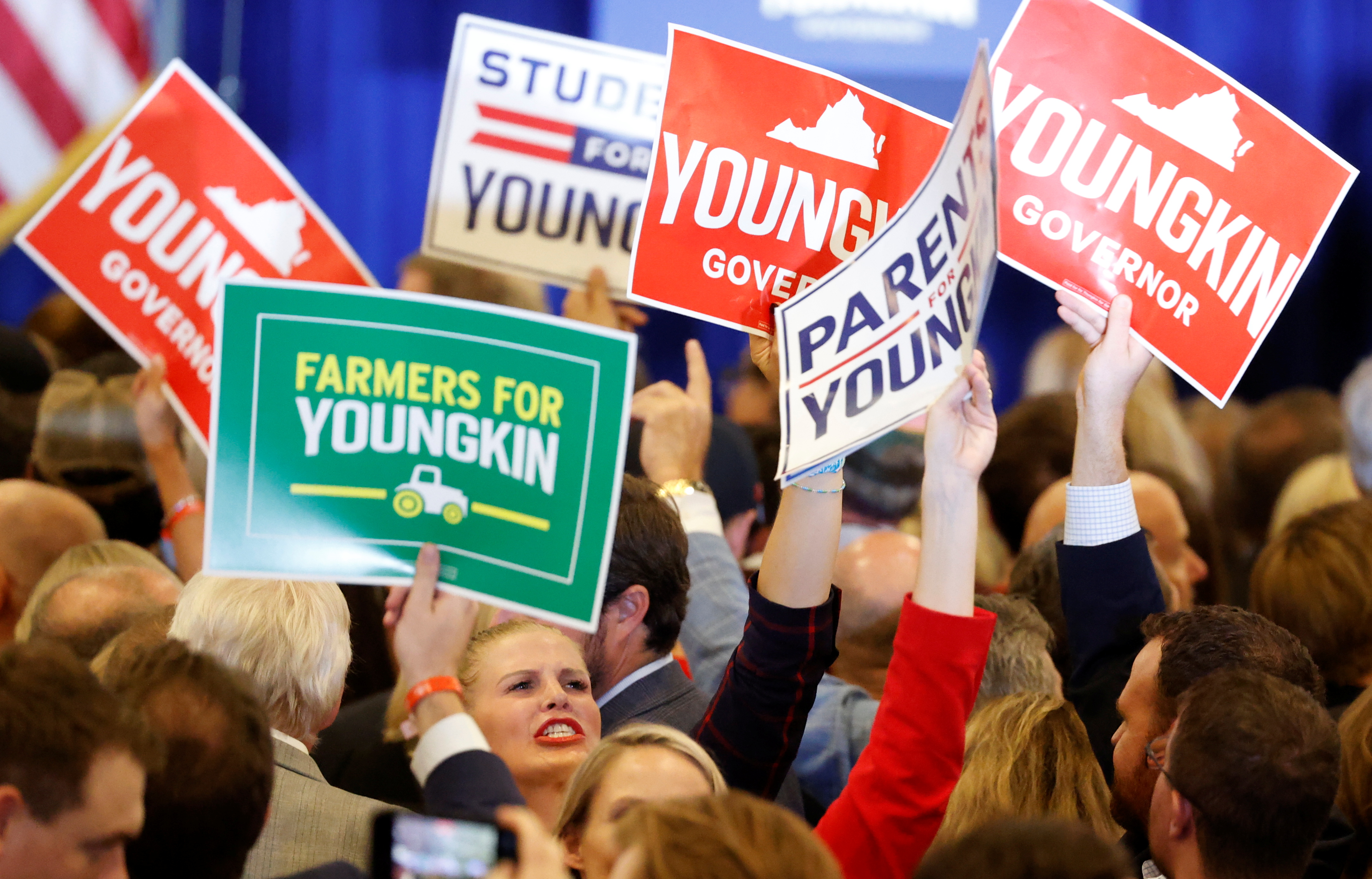 Supporters of Republican nominee for Governor of Virginia Glenn Youngkin celebrate as they see results come in on television during an election night party at a hotel in Chantilly, Virginia, U.S., November 2, 2021. REUTERS/ Jonathan Ernst