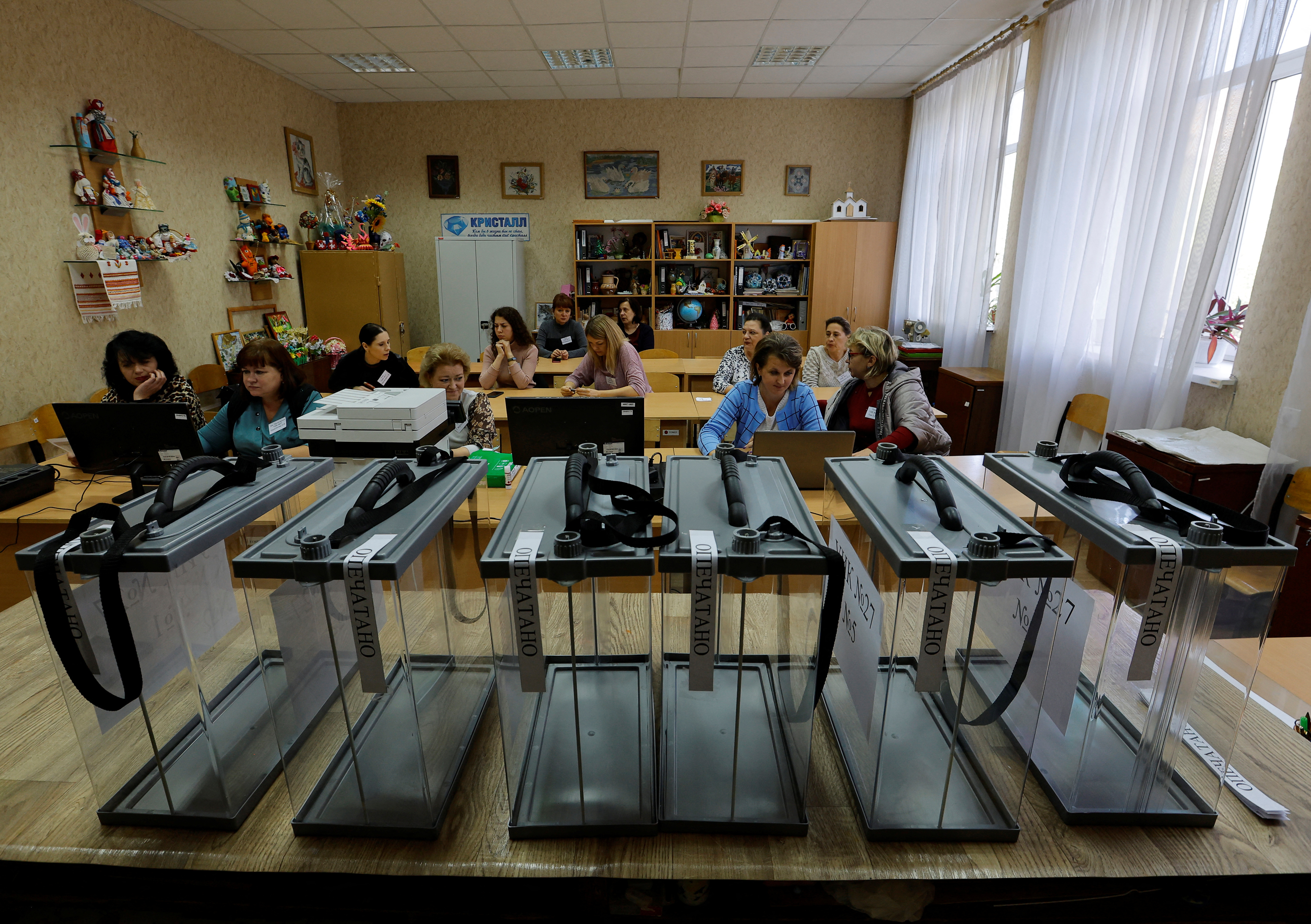 Members of the local electoral commission gather at a polling station ahead of the planned referendum in Donetsk