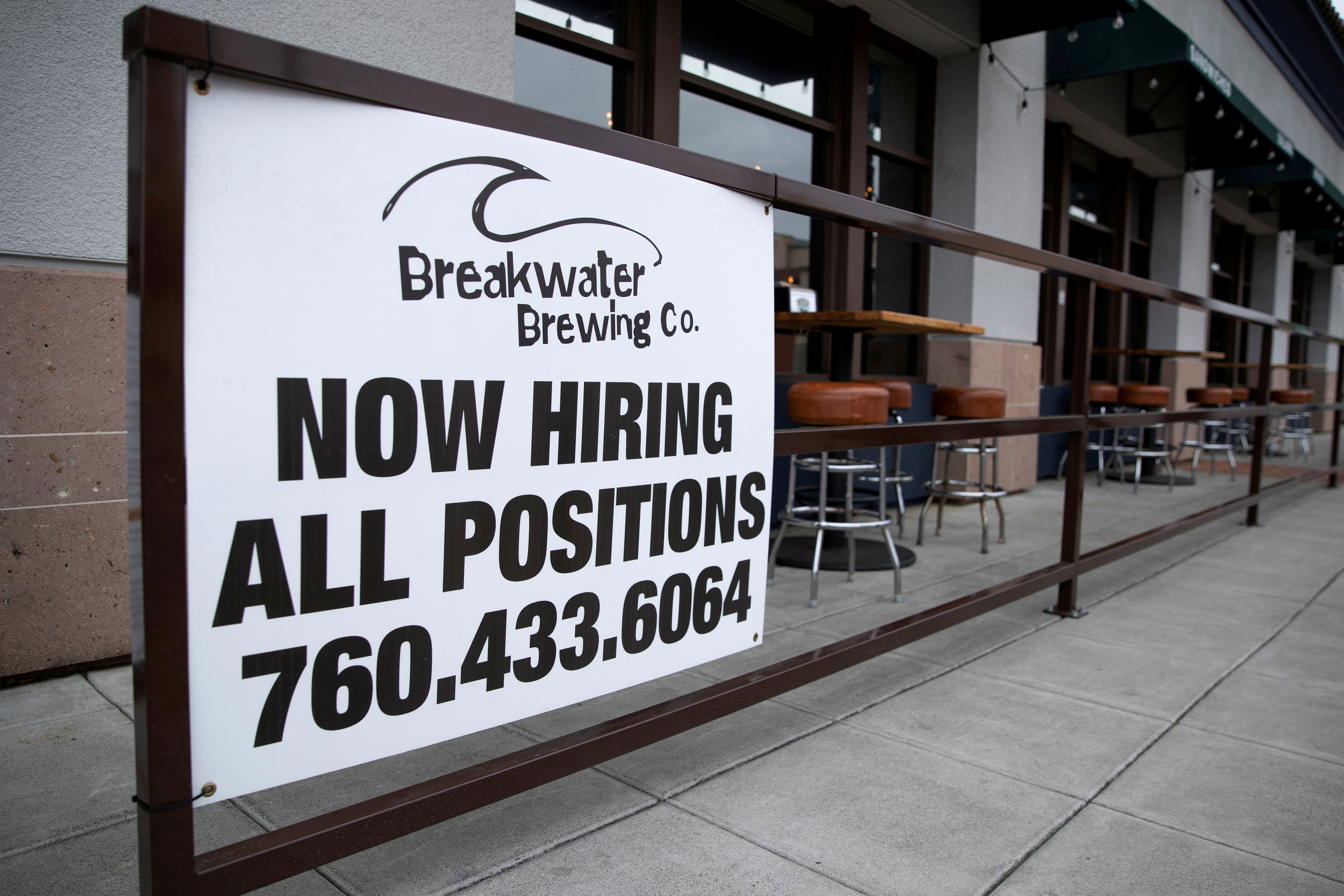 A restaurant advertising jobs looks to attract workers in Oceanside, California, U.S., May 10, 2021. REUTERS/Mike Blake/File Photo