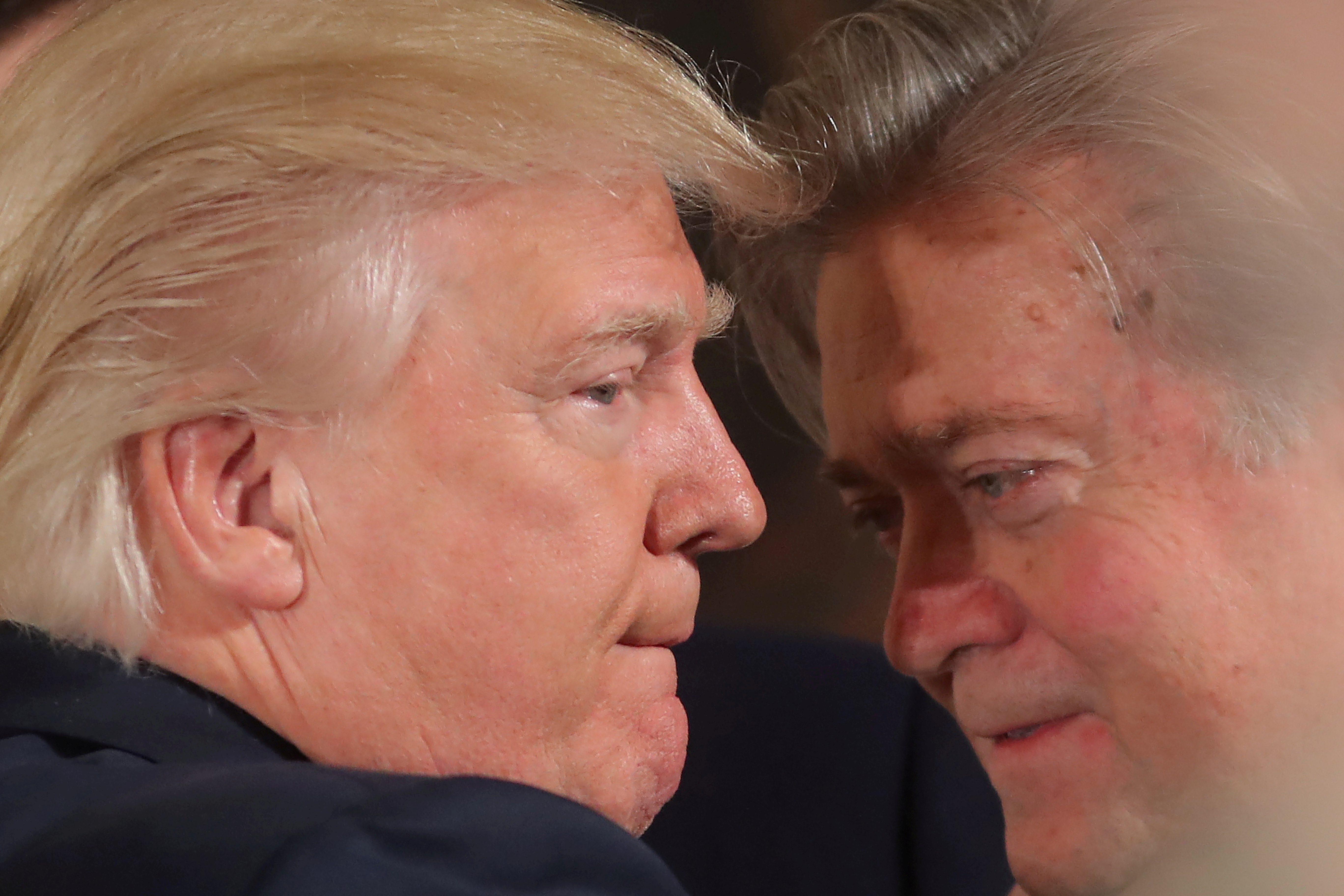 File photo  U.S. President Donald Trump talks to chief strategist Steve Bannon during a swearing in ceremony for senior staff at the White House in Washington, U.S. January 22, 2017. REUTERS/Carlos Barria