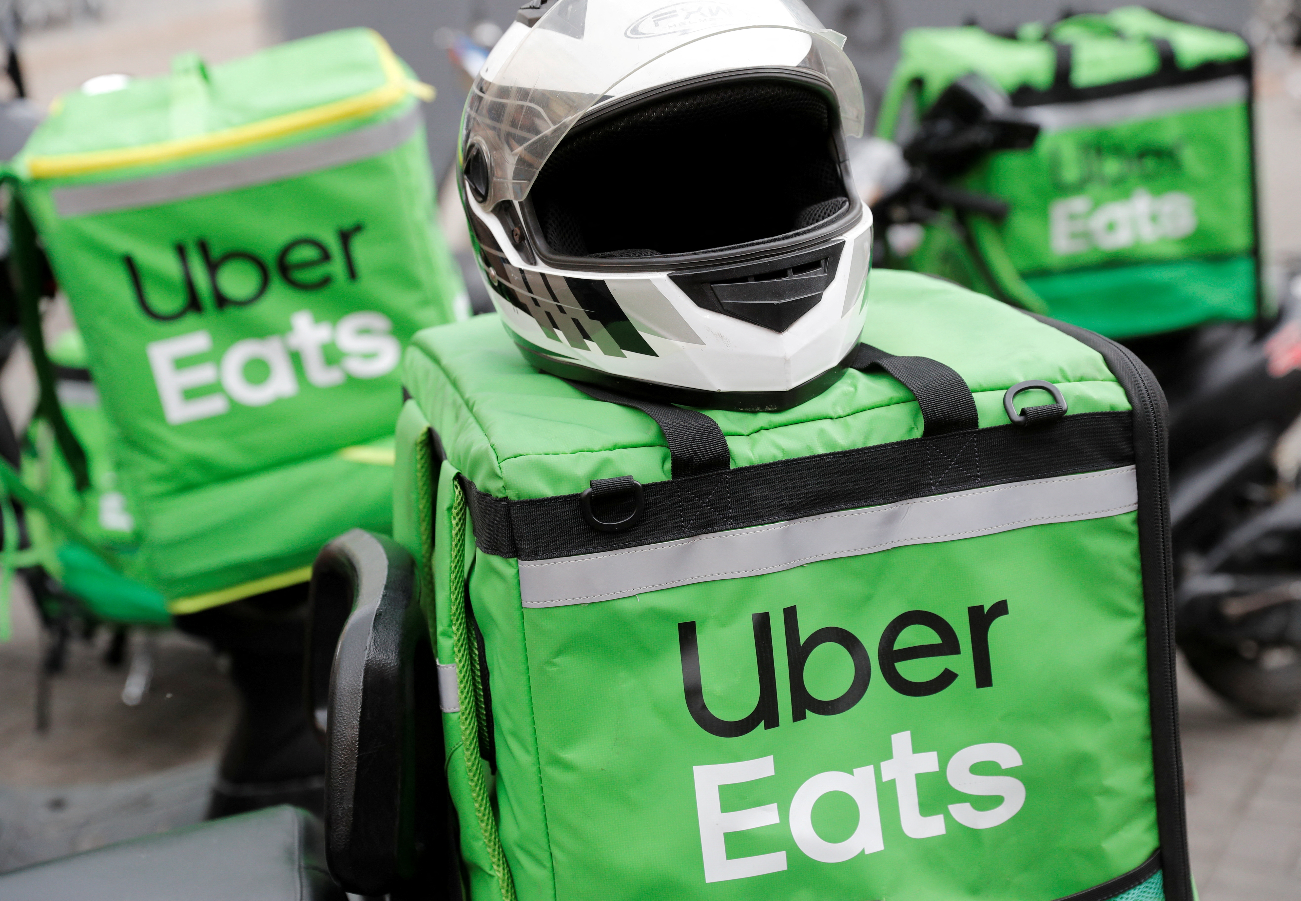 Delivery bags with logos of Uber Eats are seen on a street in central Kiev