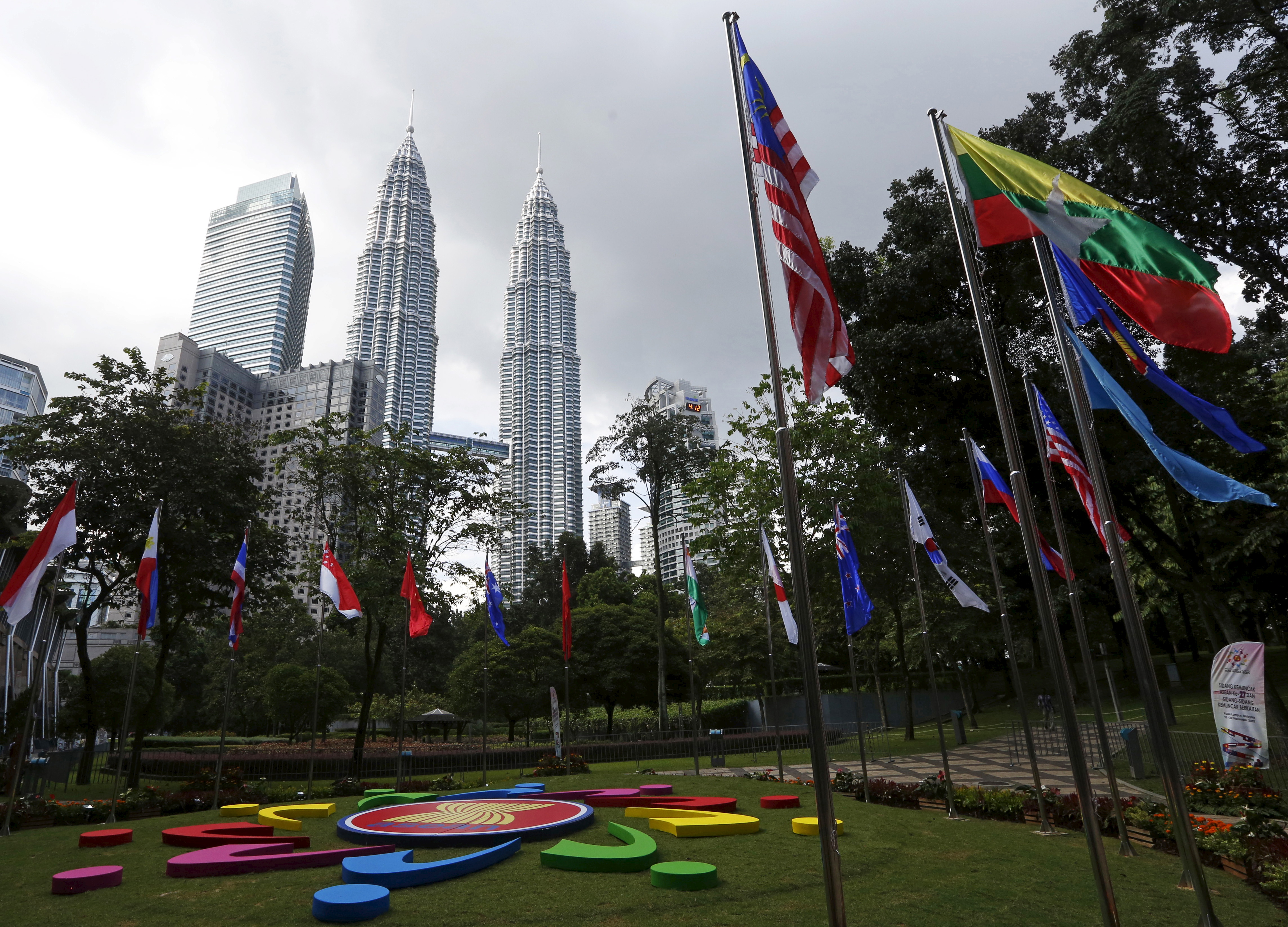 National flags and the ASEAN logo on display ahead of the 27th ASEAN summit in Kuala Lumpur, Malaysia