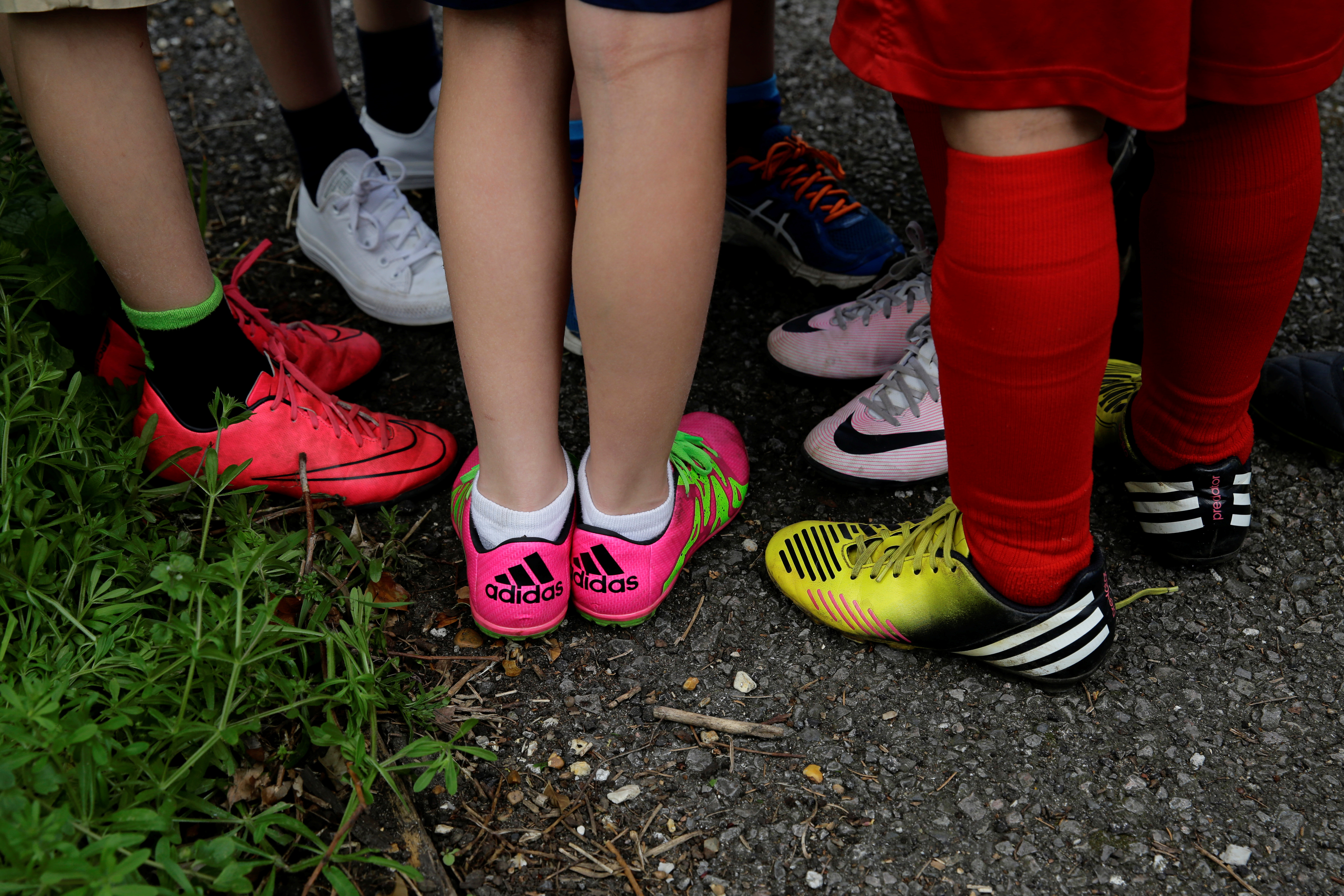 Children wearing Nike and Adidas shoes at a playground
