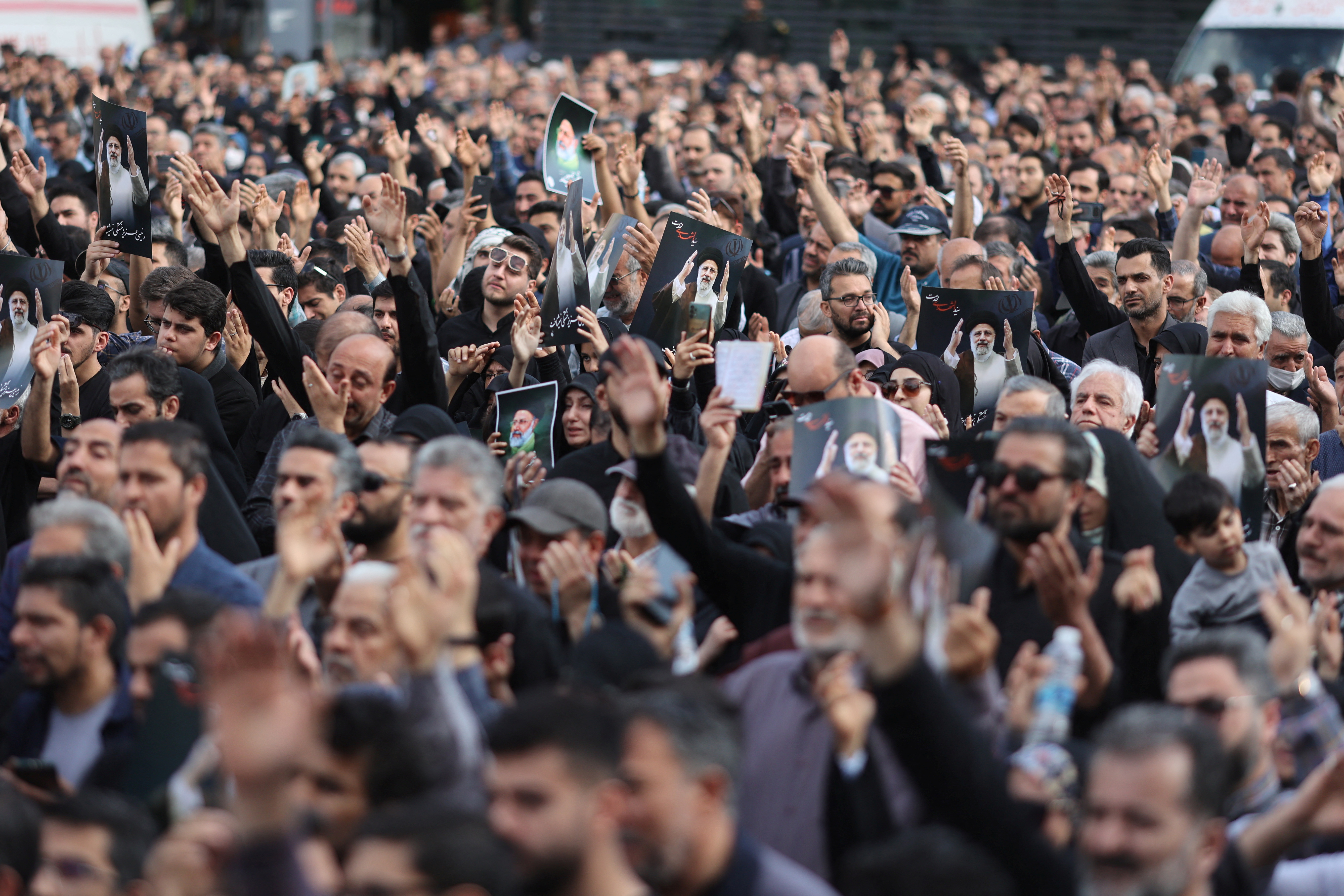 People gather to mourn for the death of the late Iran's President Ebrahim Raisi, in Tehran