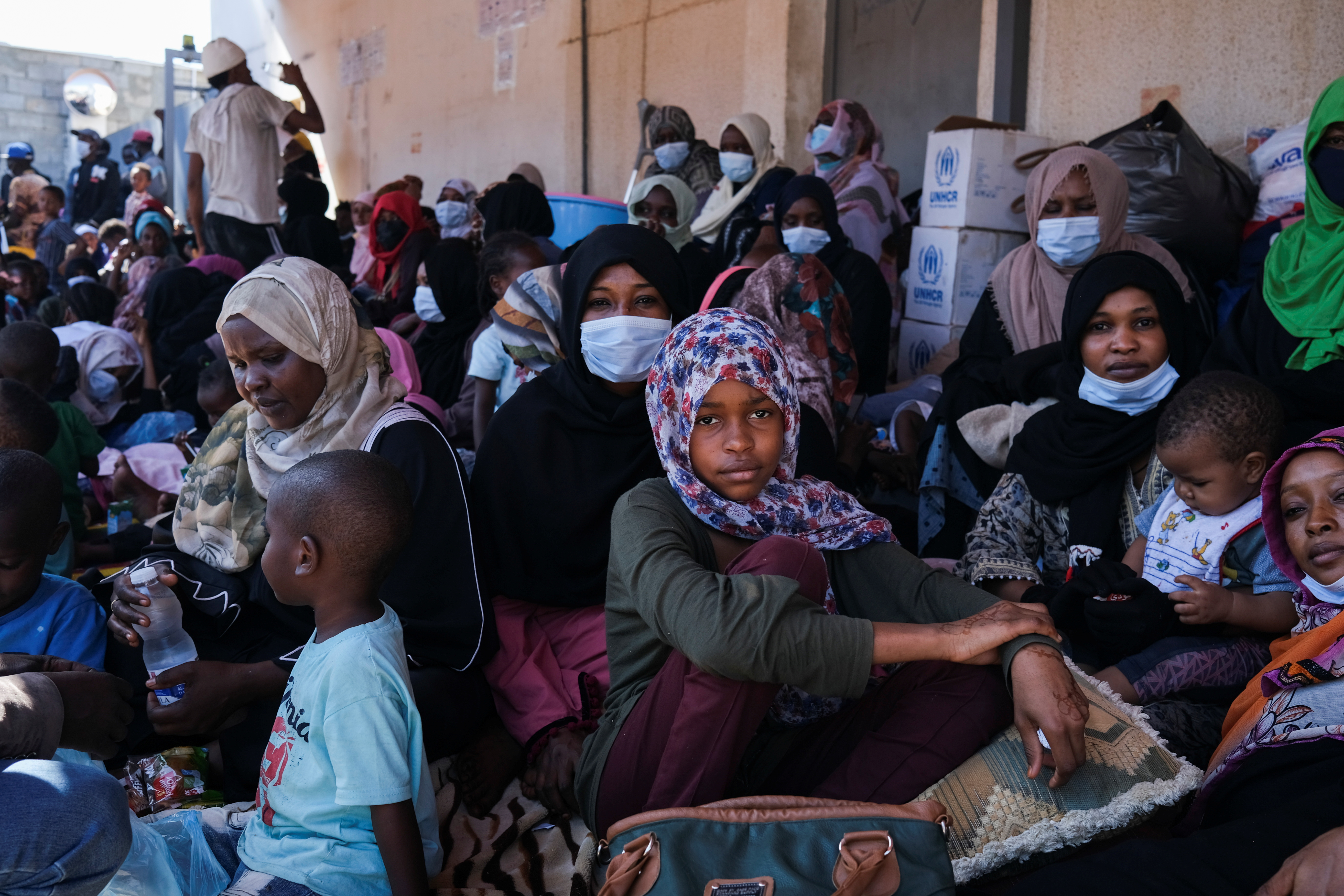 Migrants wait outside the United Nations High Commissioner for Refugees (UNHCR) negotiation office in Tripoli