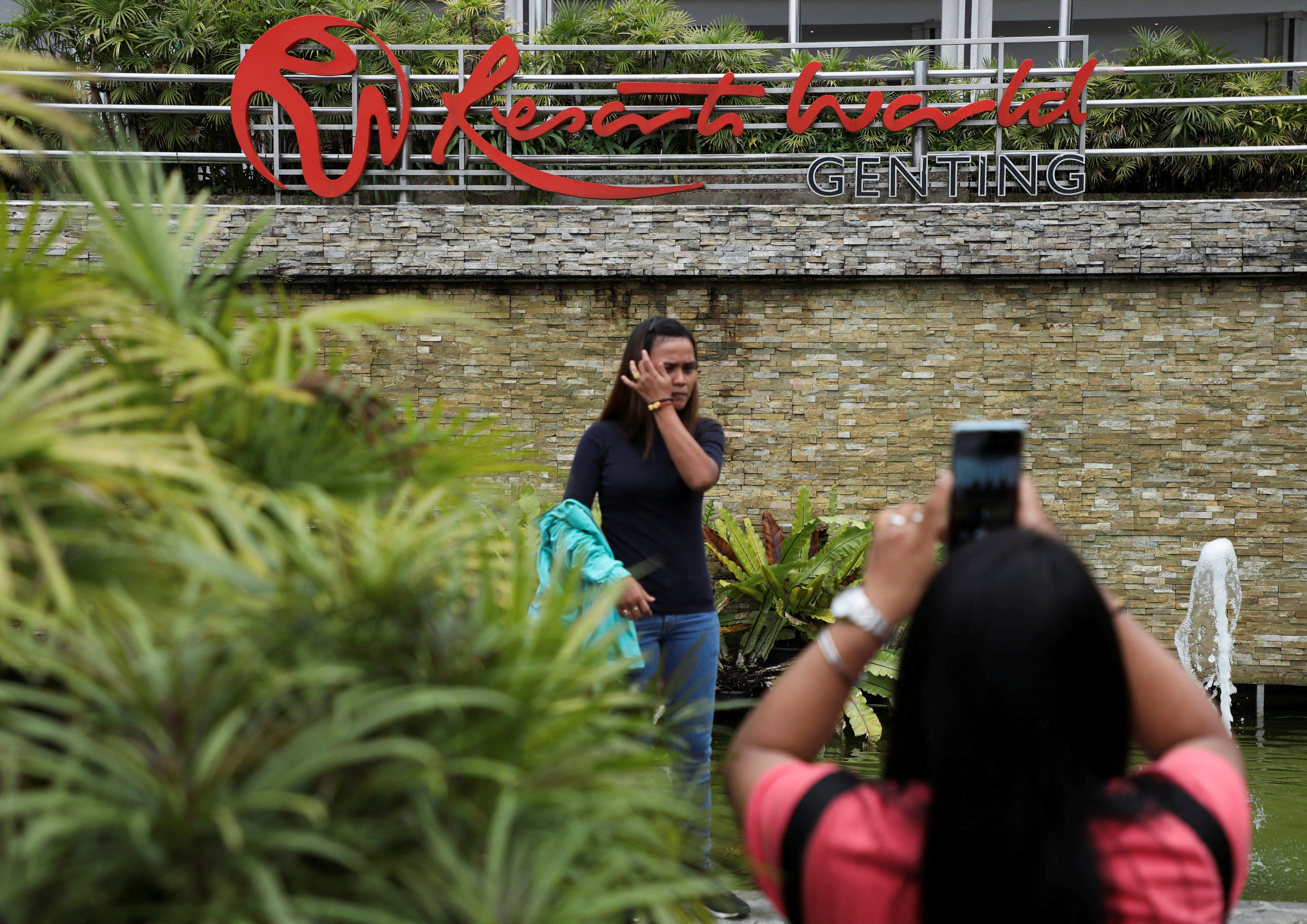Visitors take picture with the signage of Genting Malaysia’s Resorts World in Genting Highlands