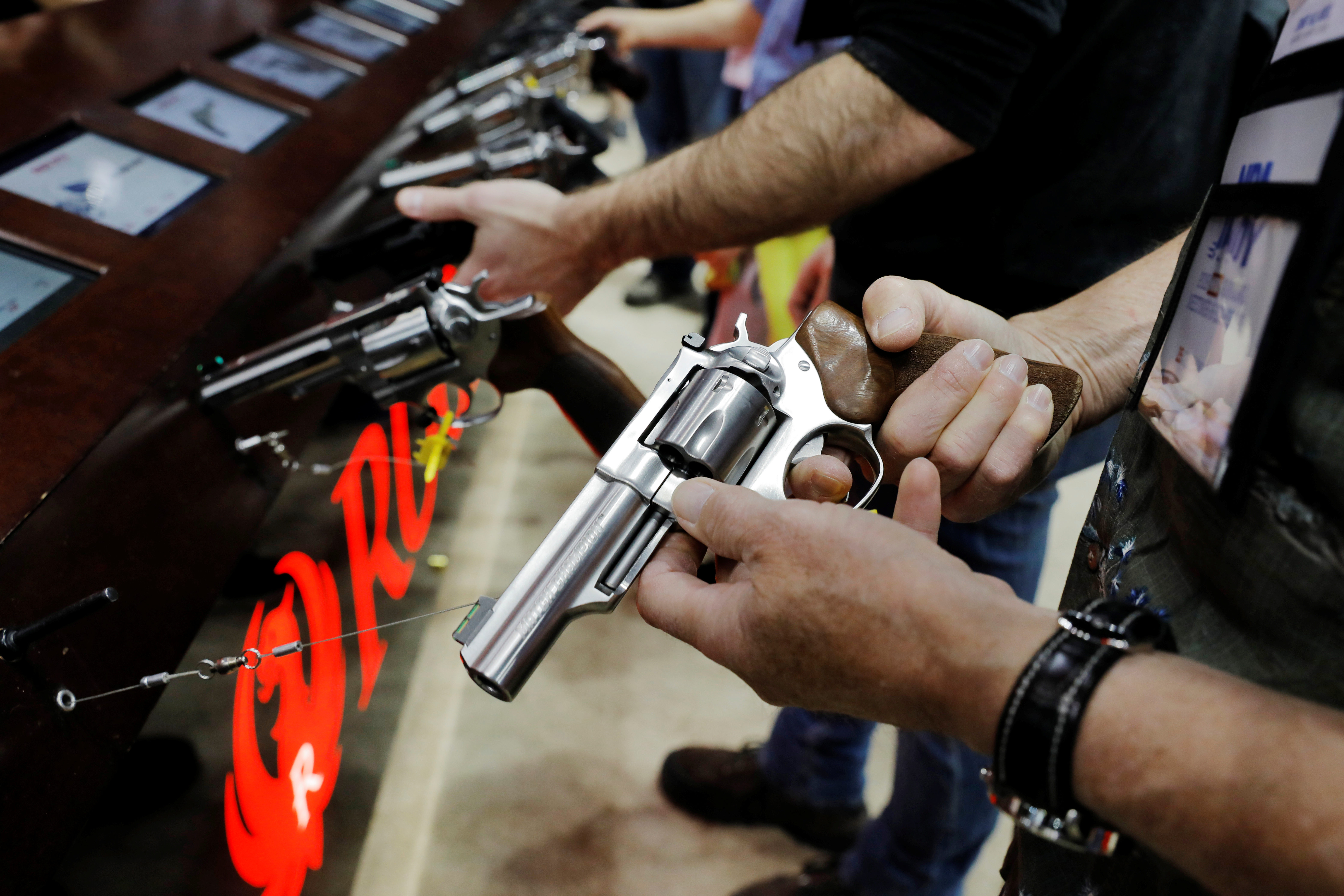 A man handles a Ruger revolver during the National Rifle Association (NRA) annual meeting in Indianapolis, Indiana