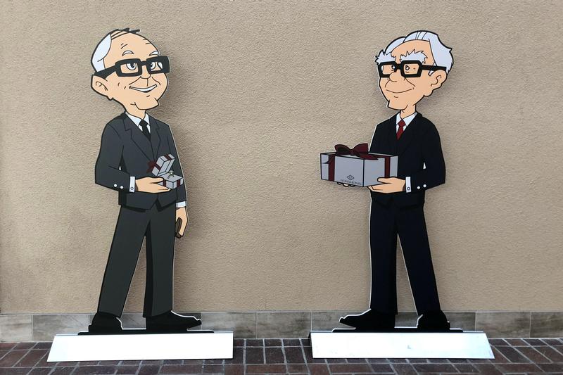 Caricatures of Charlie Munger and Warren Buffett appear in Omaha