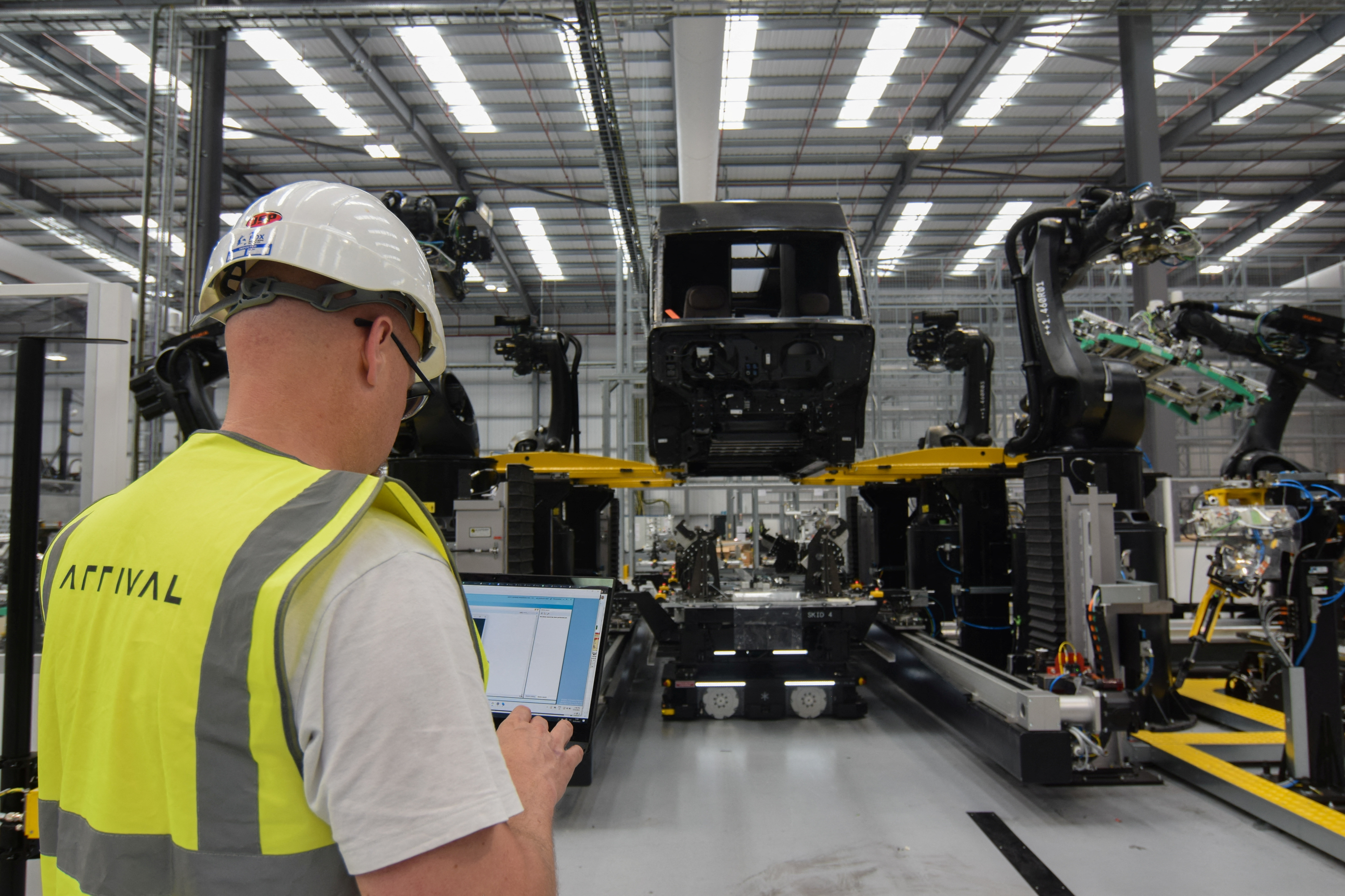 An engineer at electric van maker Arrival checks a prototype vehicle under construction at the company's factory in Bicester