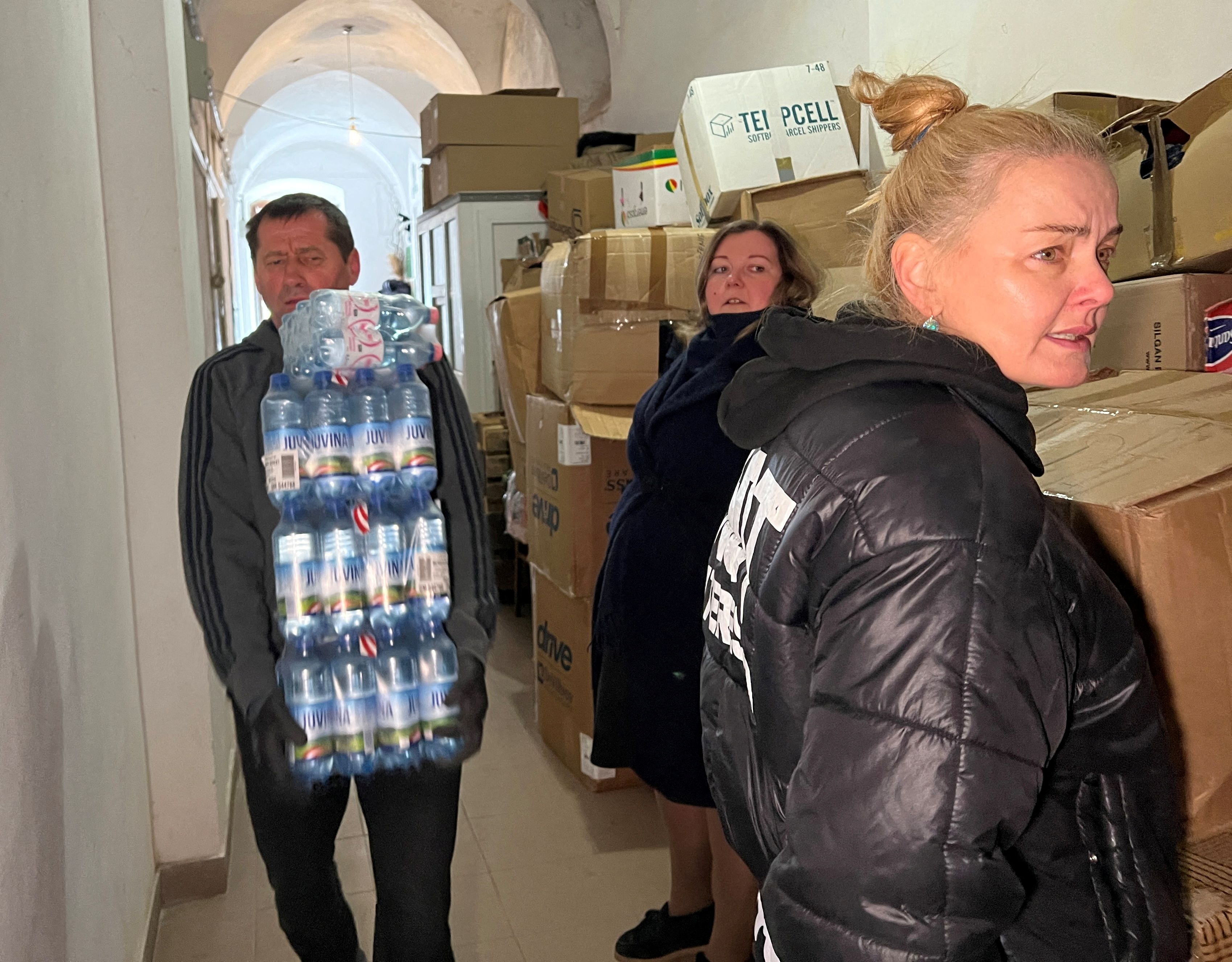 Ukrainian refugee Luidmyla Nazarova directs volunteers delivering humanitarian aid to St. George's Cathedral, in Lviv
