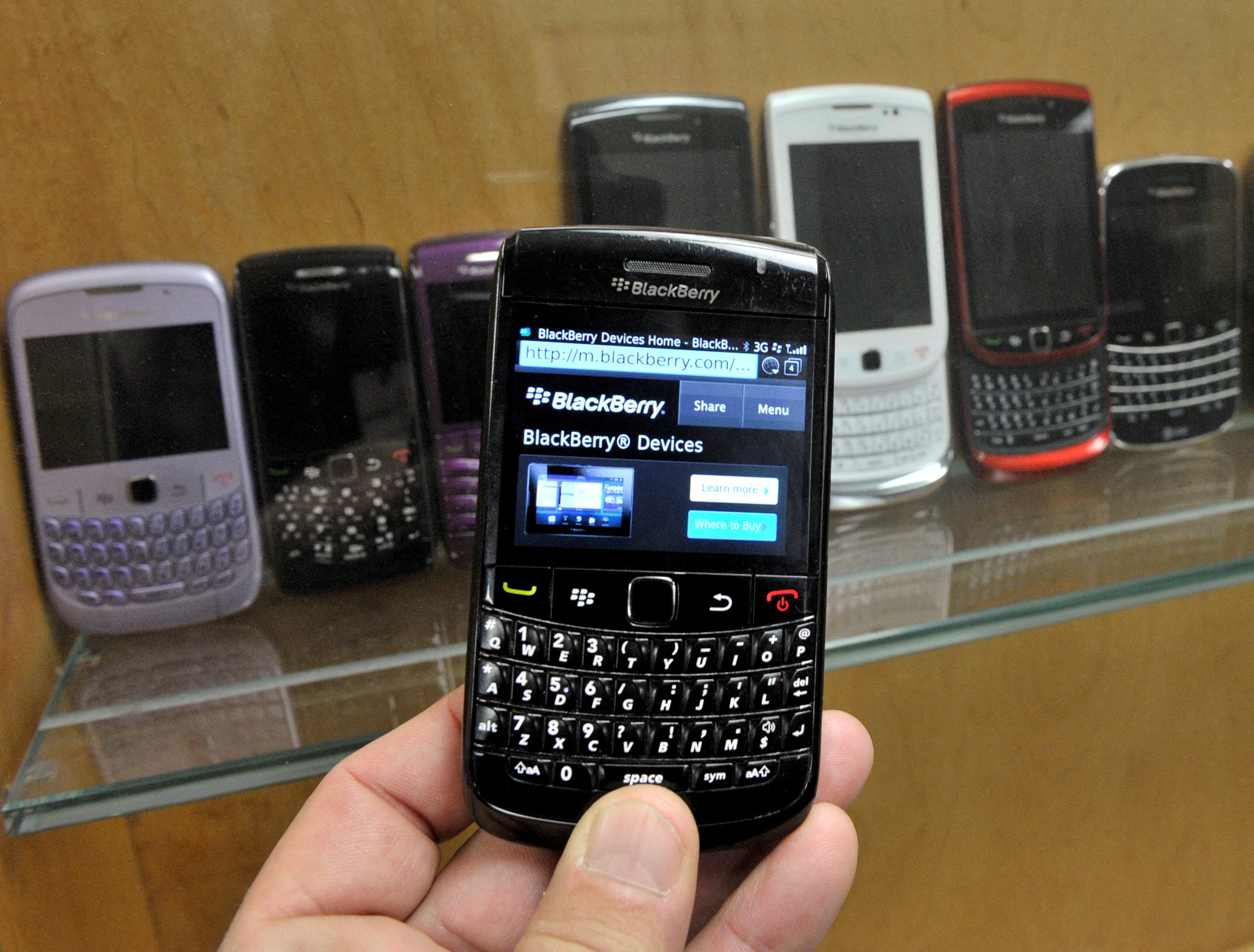 A BlackBerry device is shown in front of products displayed in a glass cabinet at the Research in Motion offices in Waterloo November 14, 2012.