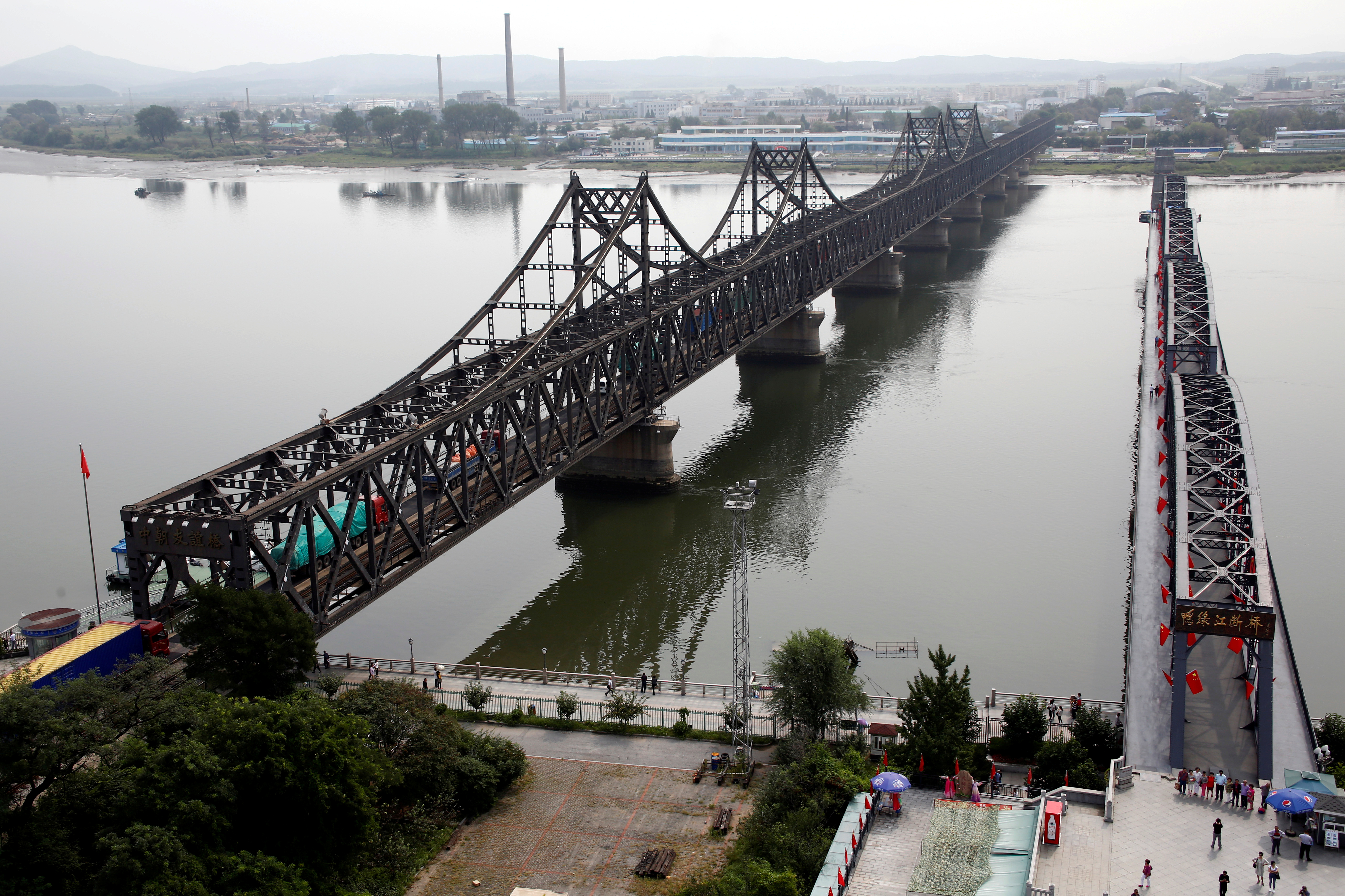 Trucks cross Friendship Bridge from China's Dandong, Liaoning province, to North Korea's Sinuiju
