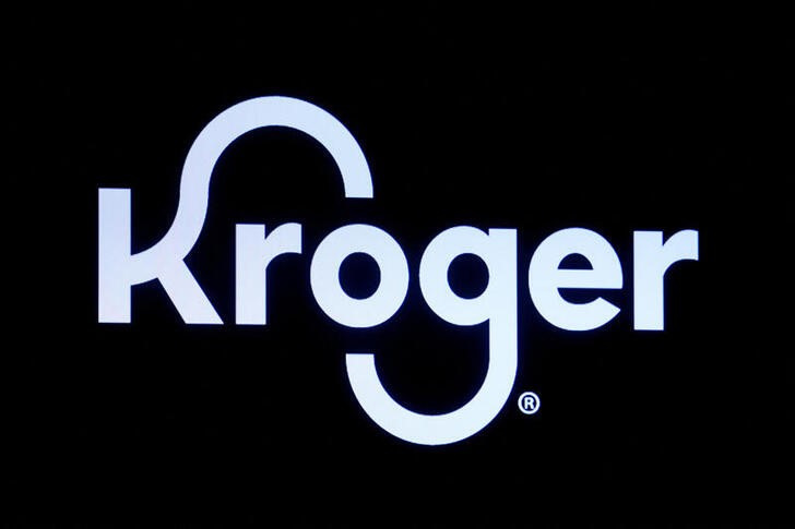 A screen displays the company logo for Kroger Co on the floor of the NYSE in New York