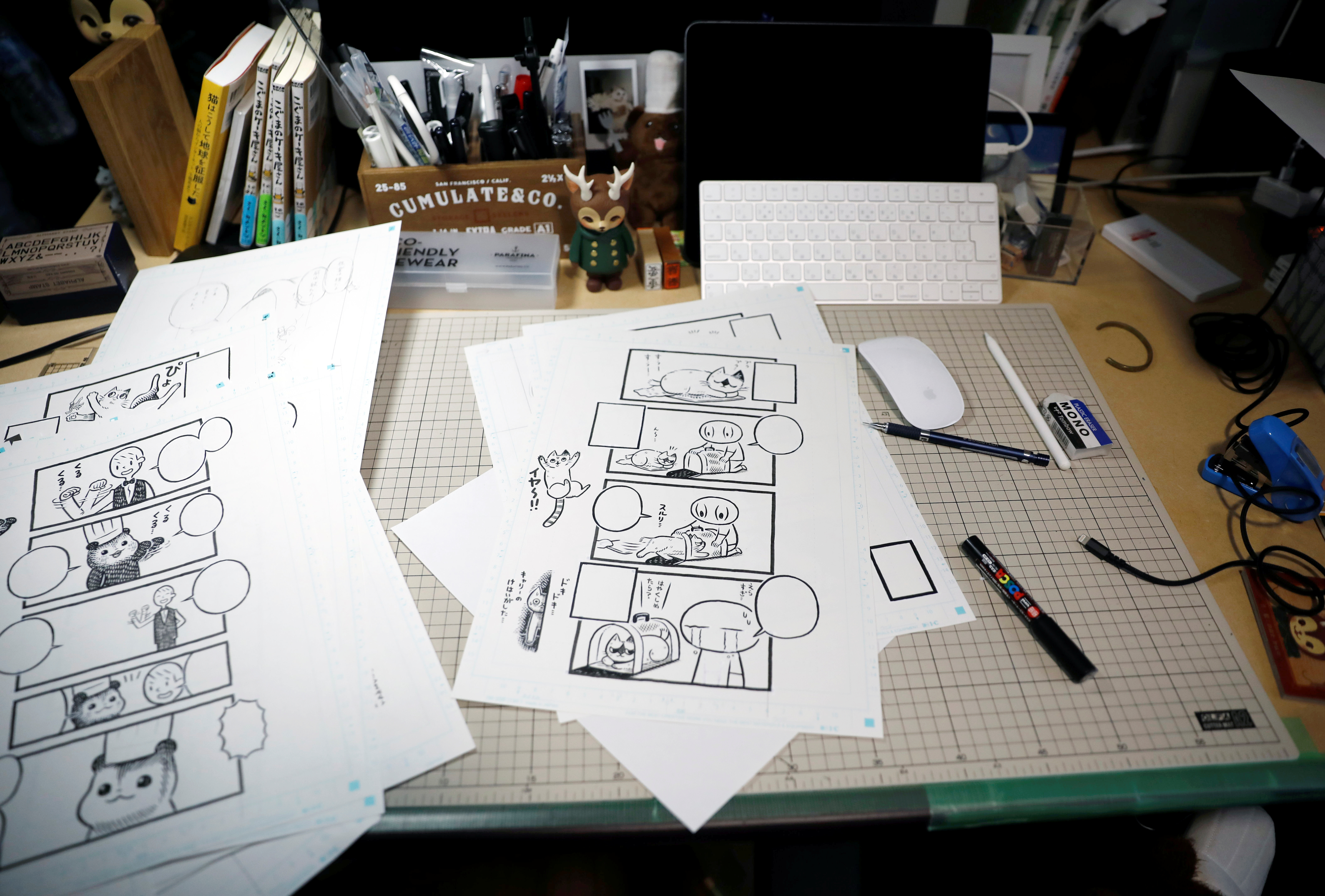 Sheets with four-panel strip comic 'Koguma's Cake Shop' are seen at his workspace in Tokyo