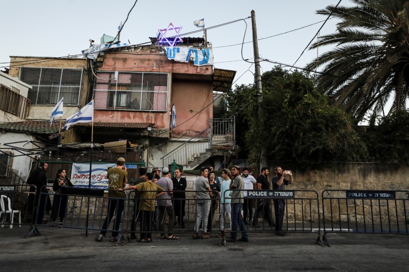 Orthodox Jewish youth stand next to an Israeli police barricade in Sheikh Jarrah neighbourhood where Palestinian families face possible eviction after an Israeli court accepted Jewish settler land claims, in East Jerusalem