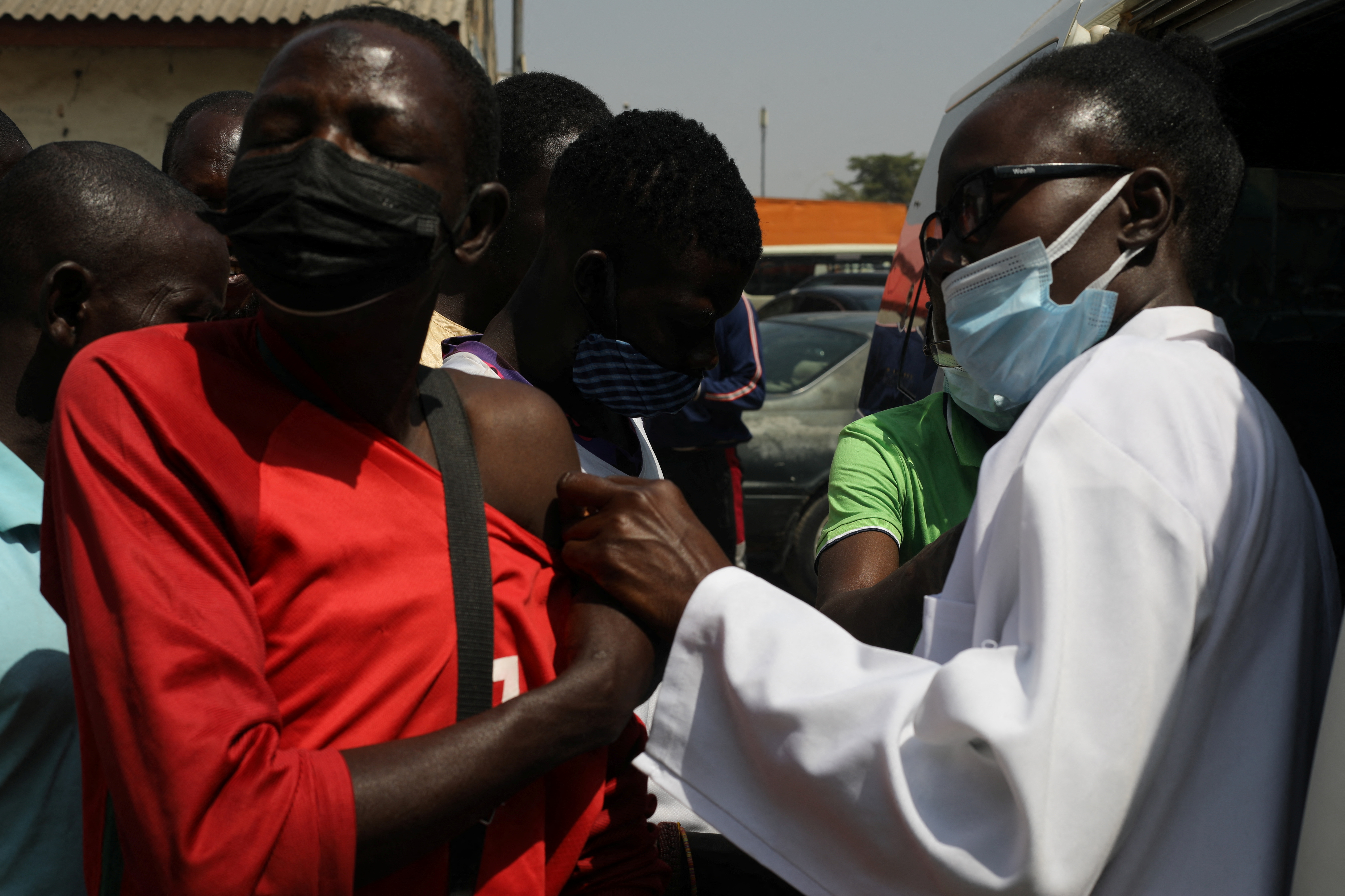 A man receives a dose of the COVID-19 vaccine during a mass vaccination exercise at Wuse market in Abuja