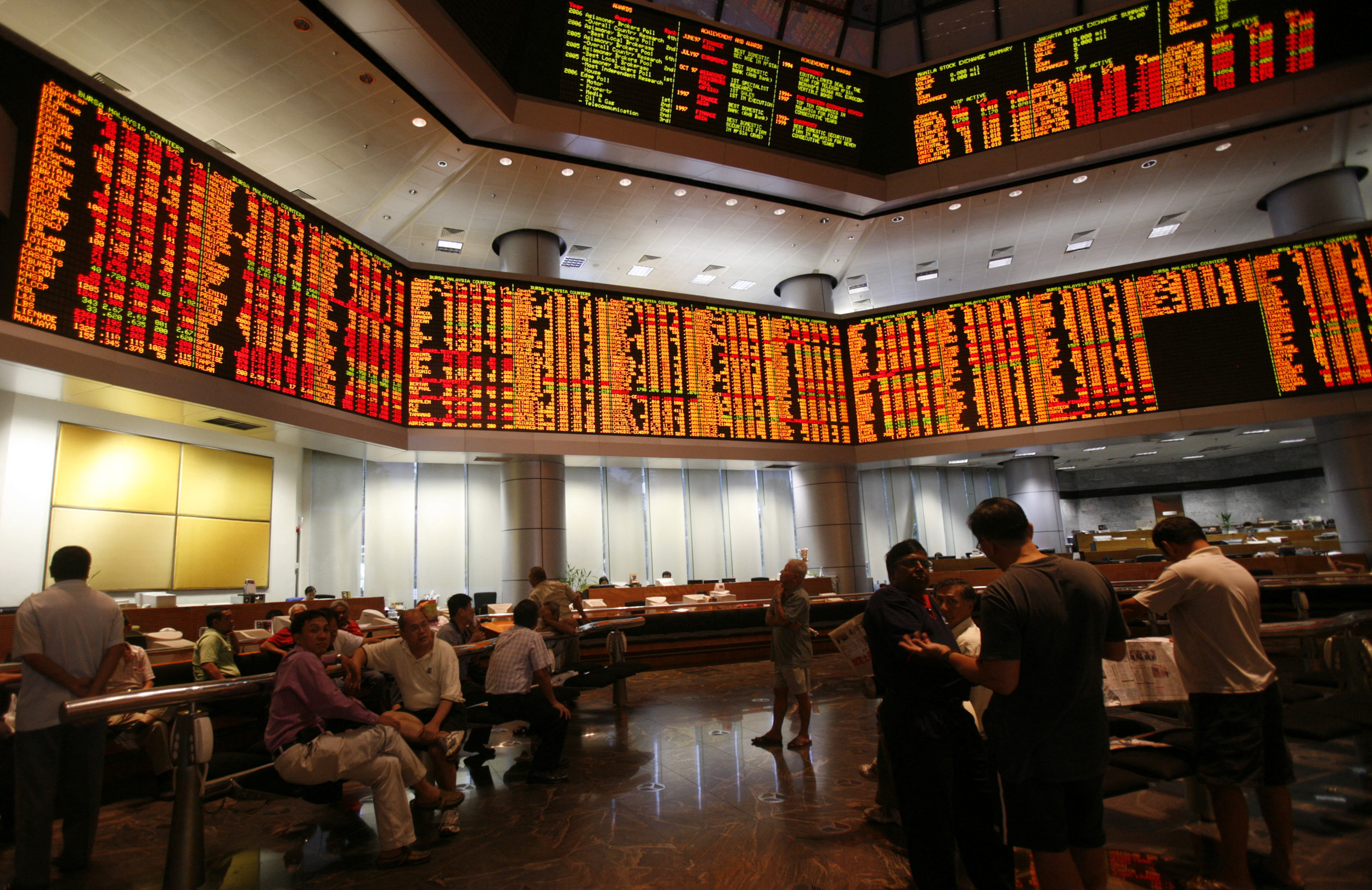 Investors monitor share market prices in Kuala Lumpur