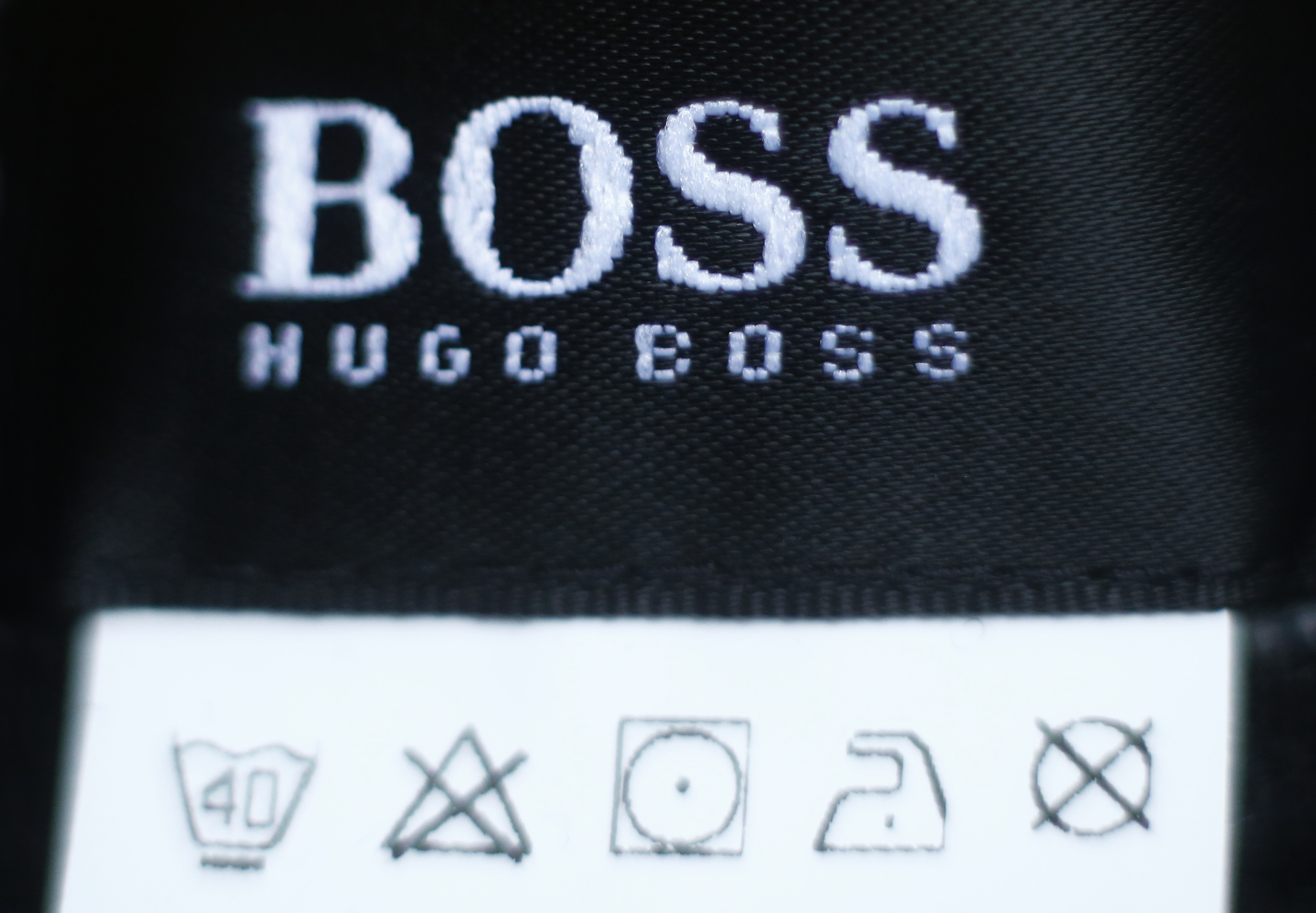 The logo of German fashion house Hugo Boss is seen on a clothing label at their outlet store in Mezingen near Stuttgart