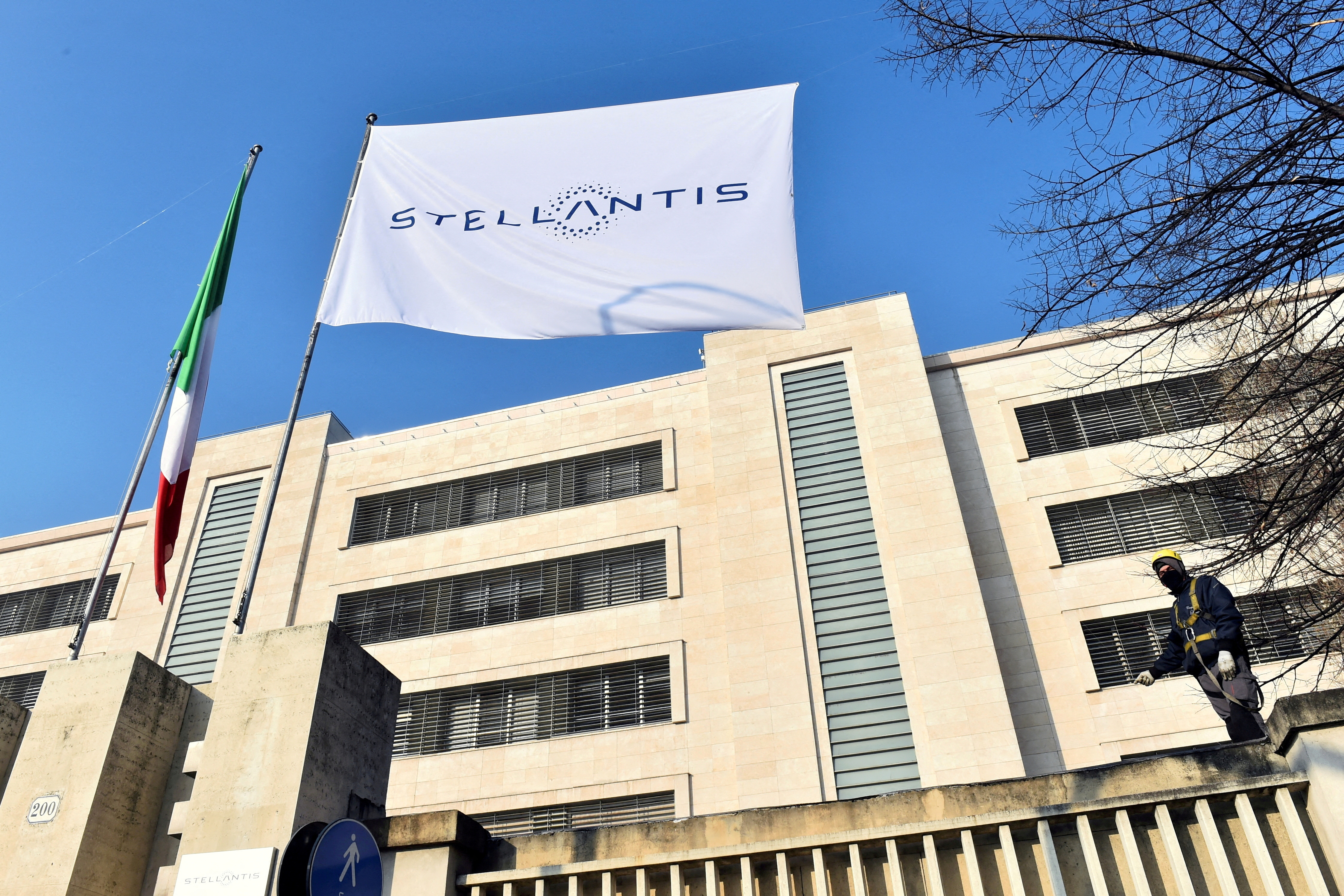 The logo of Stellantis is seen on a flag at the main entrance of FCA Mirafiori plant in Turin