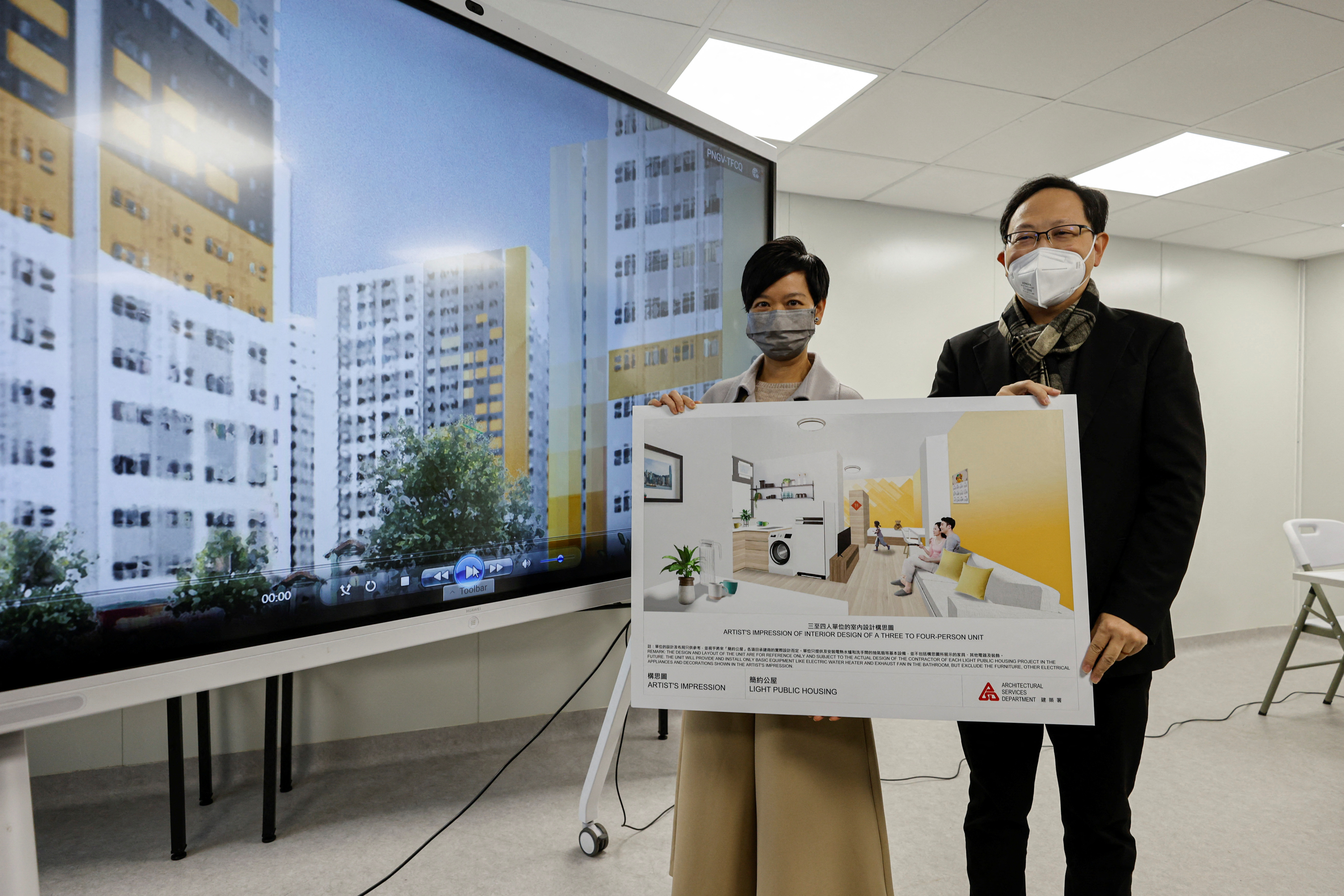 Secretary for Housing Winnie Ho Wing-yin and Project Manager of the Architectural Services Department Edward Wong pose for photos before a news conference in Hong Kong