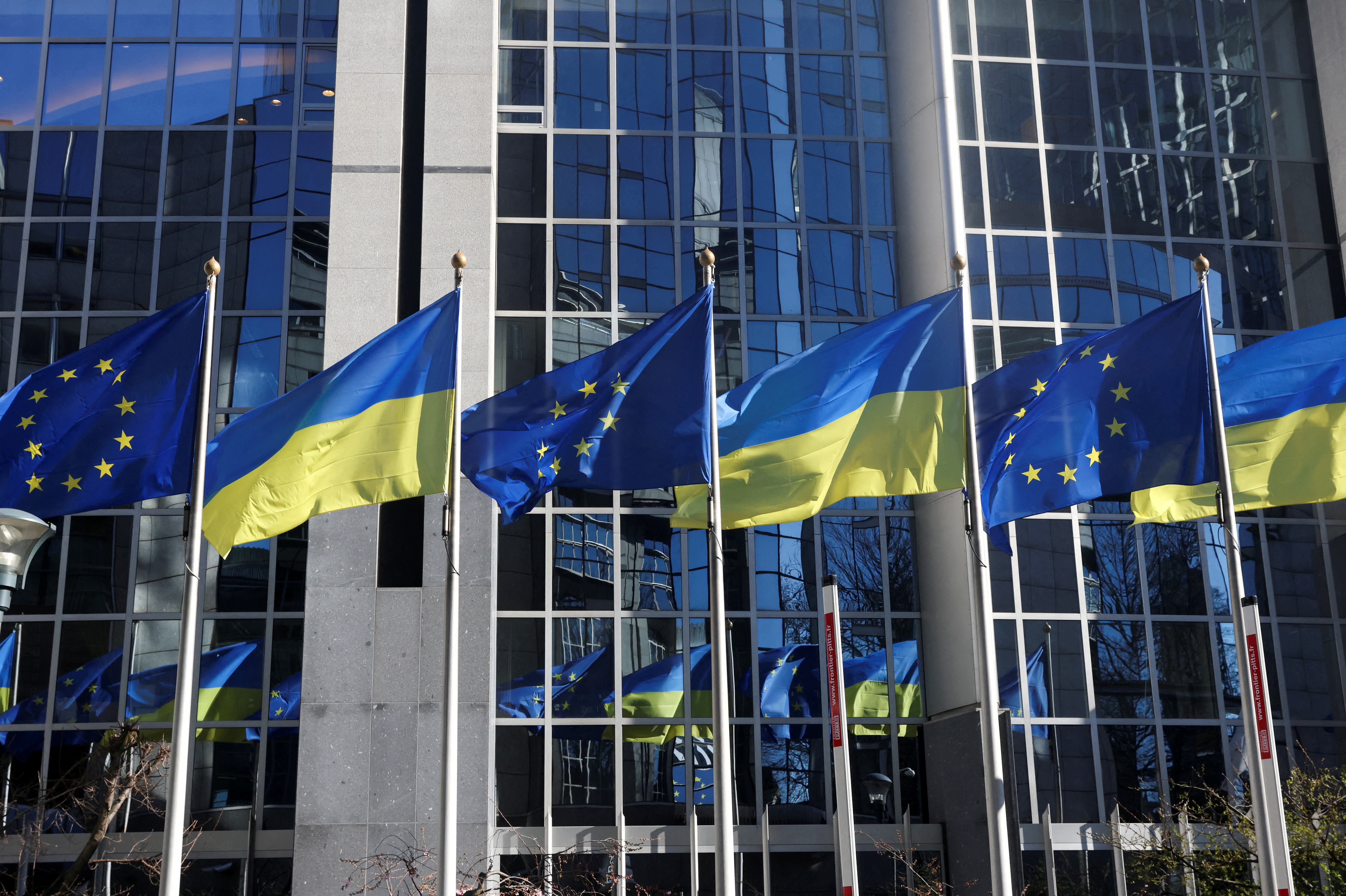 Flags of European Union and Ukraine flutter outside EU Parliament building, in Brussels