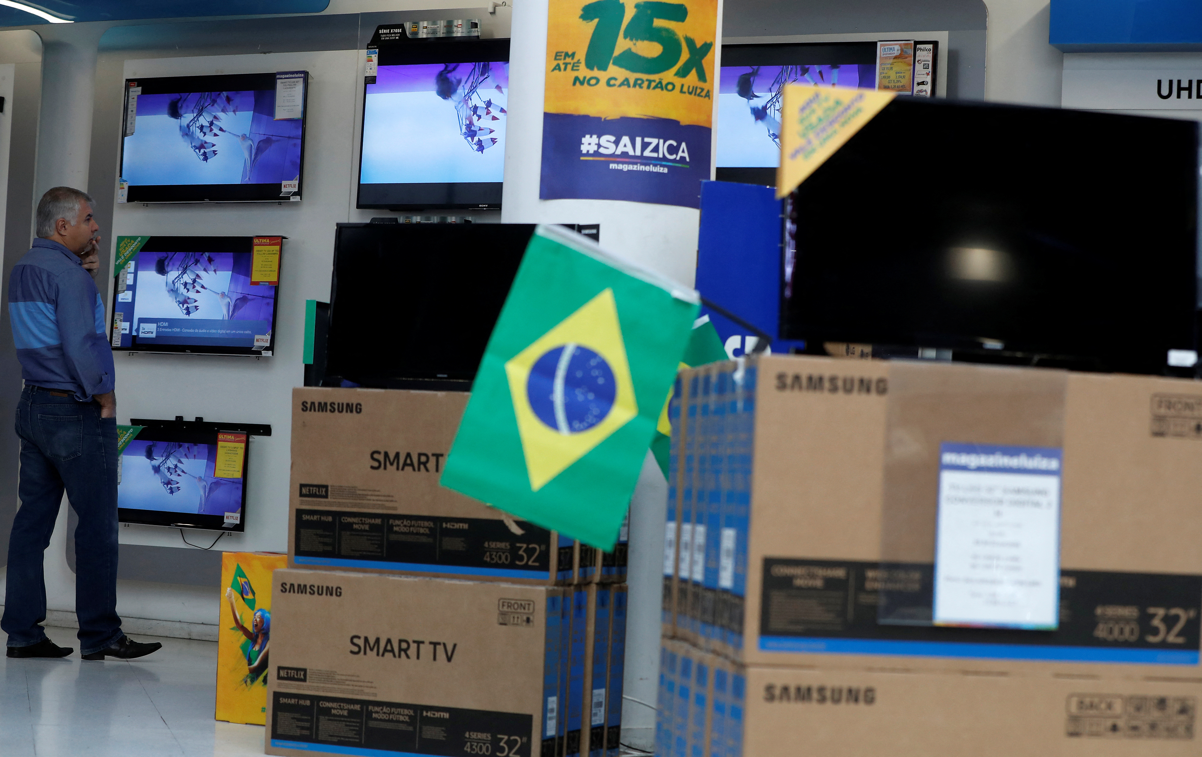 A man checks prices of television sets for sale in a store in Sao Paulo